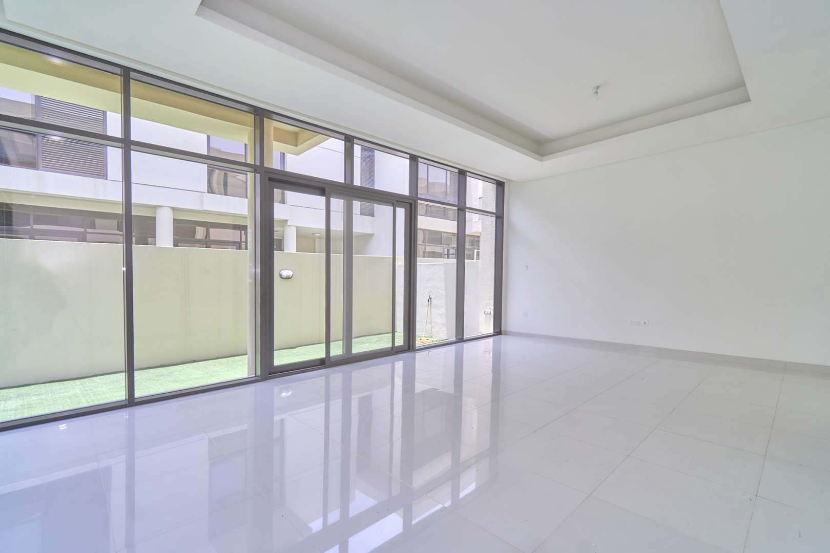 Spacious living area with large windows in Damac Hills Richmond townhouse for rent