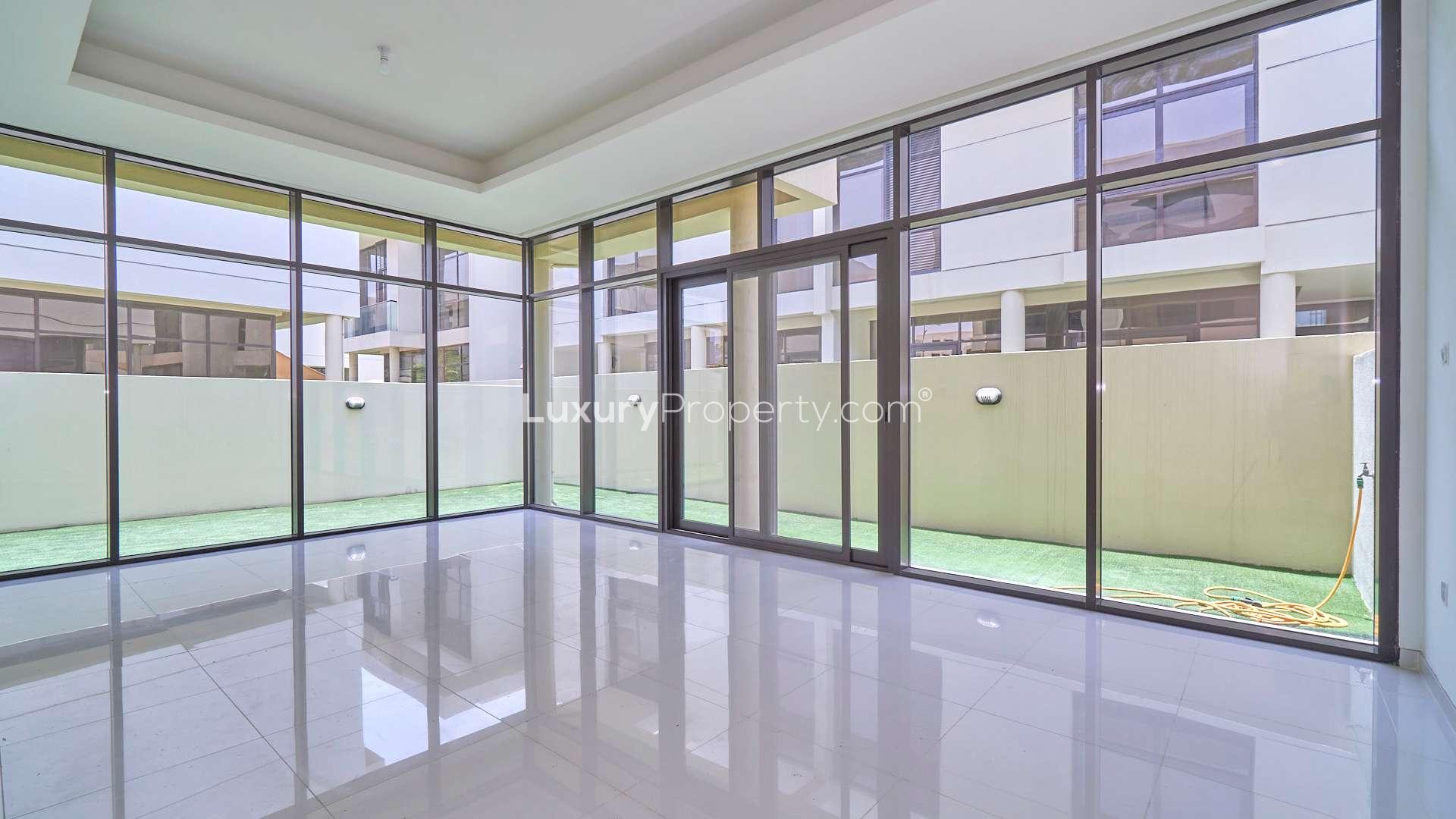 Spacious 3-bedroom townhouse exterior with carport in Richmond, Damac Hills for rent