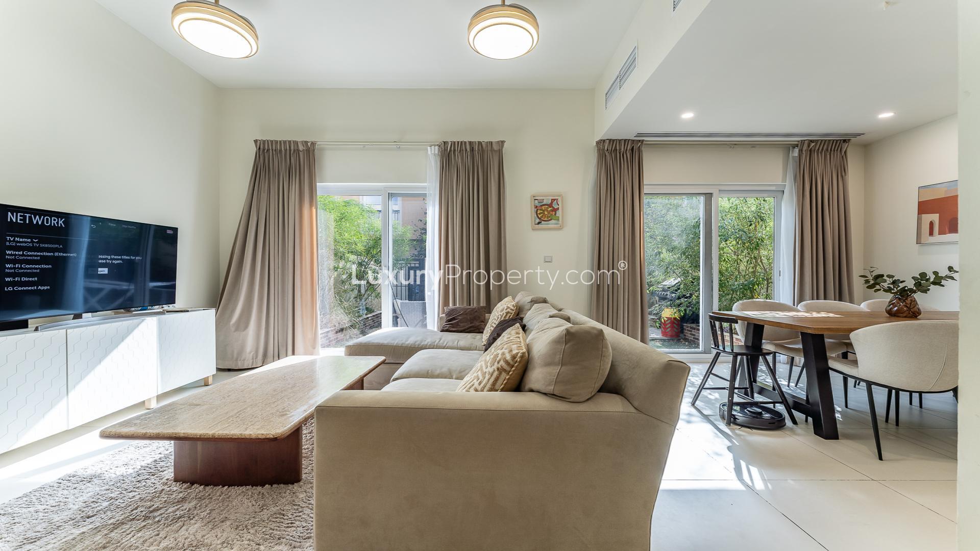 Dining area in Villanova Amaranta townhouse with wooden table and modern decor