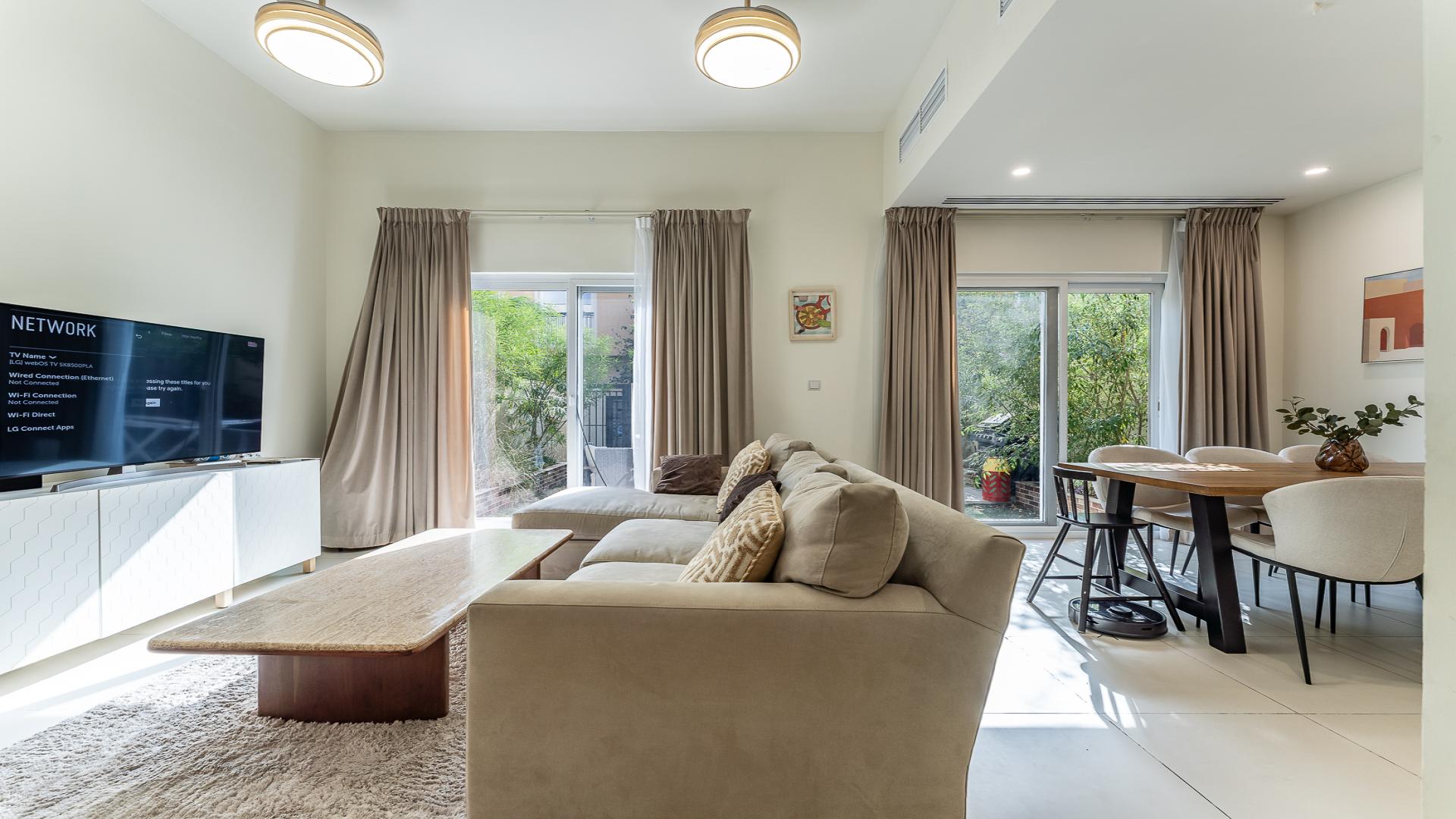 Dining area in Villanova Amaranta townhouse with wooden table and modern decor