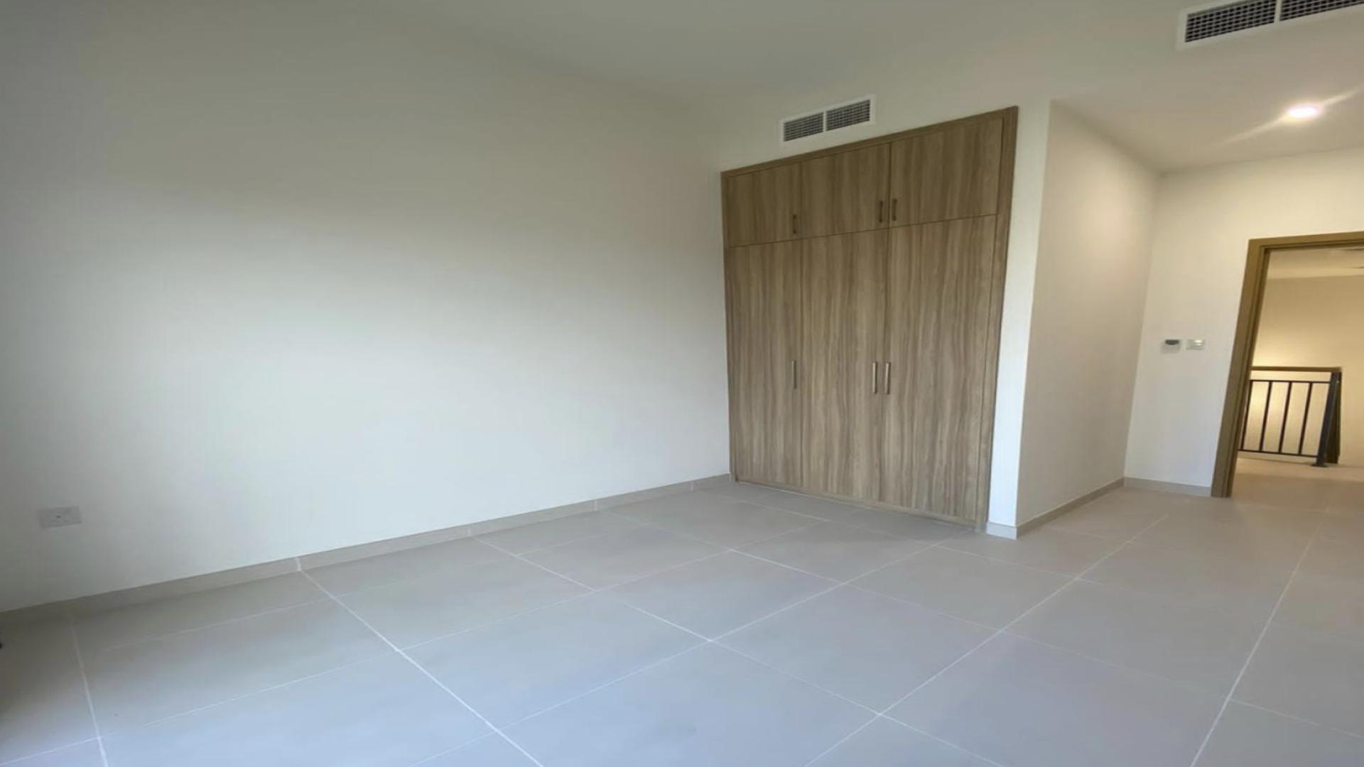 Empty bedroom with built-in wardrobe in Amaranta townhouse, Villanova, Dubai