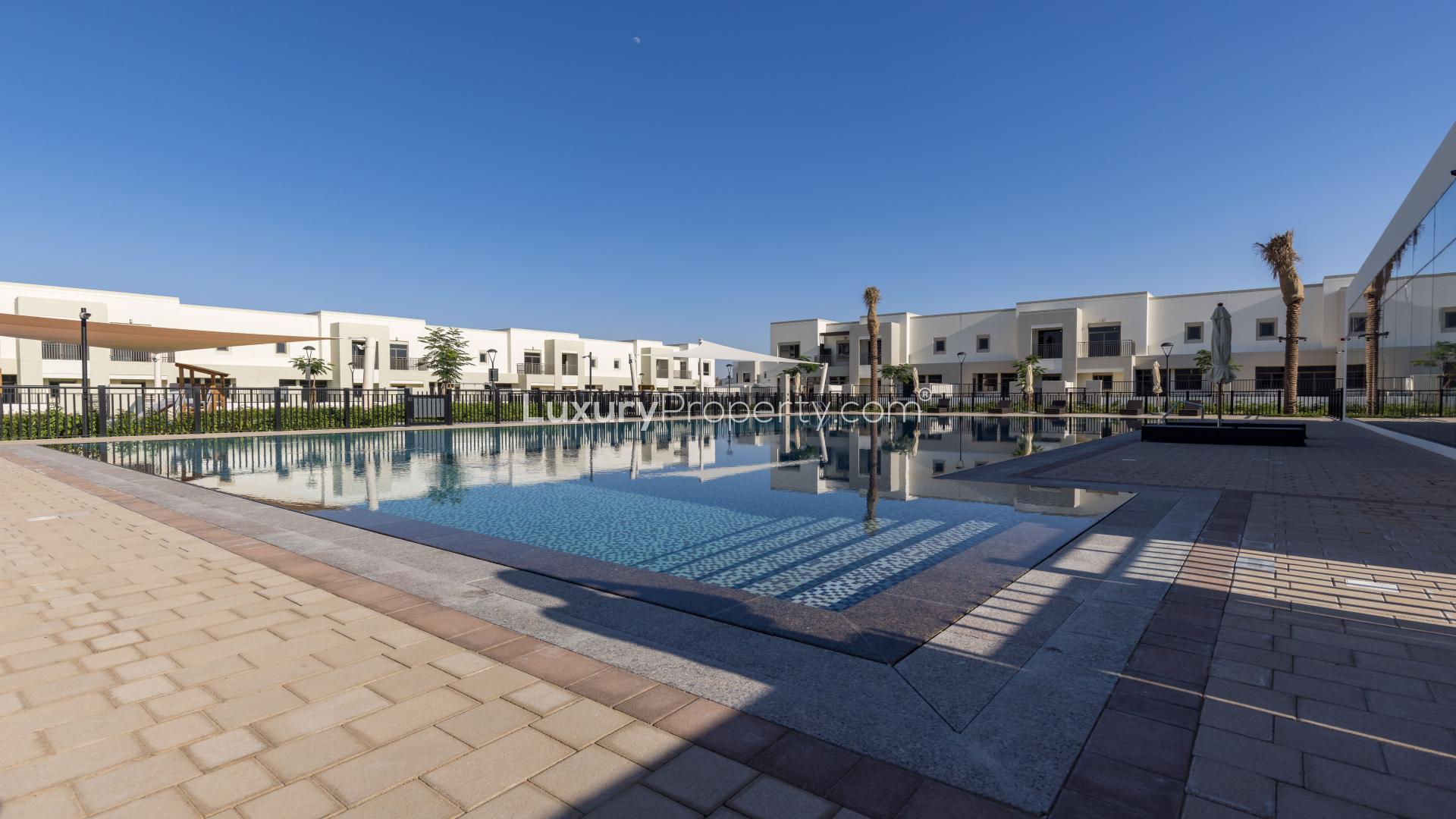 Modern gym in Sama Townhouses, Town Square, with exercise equipment and large windows