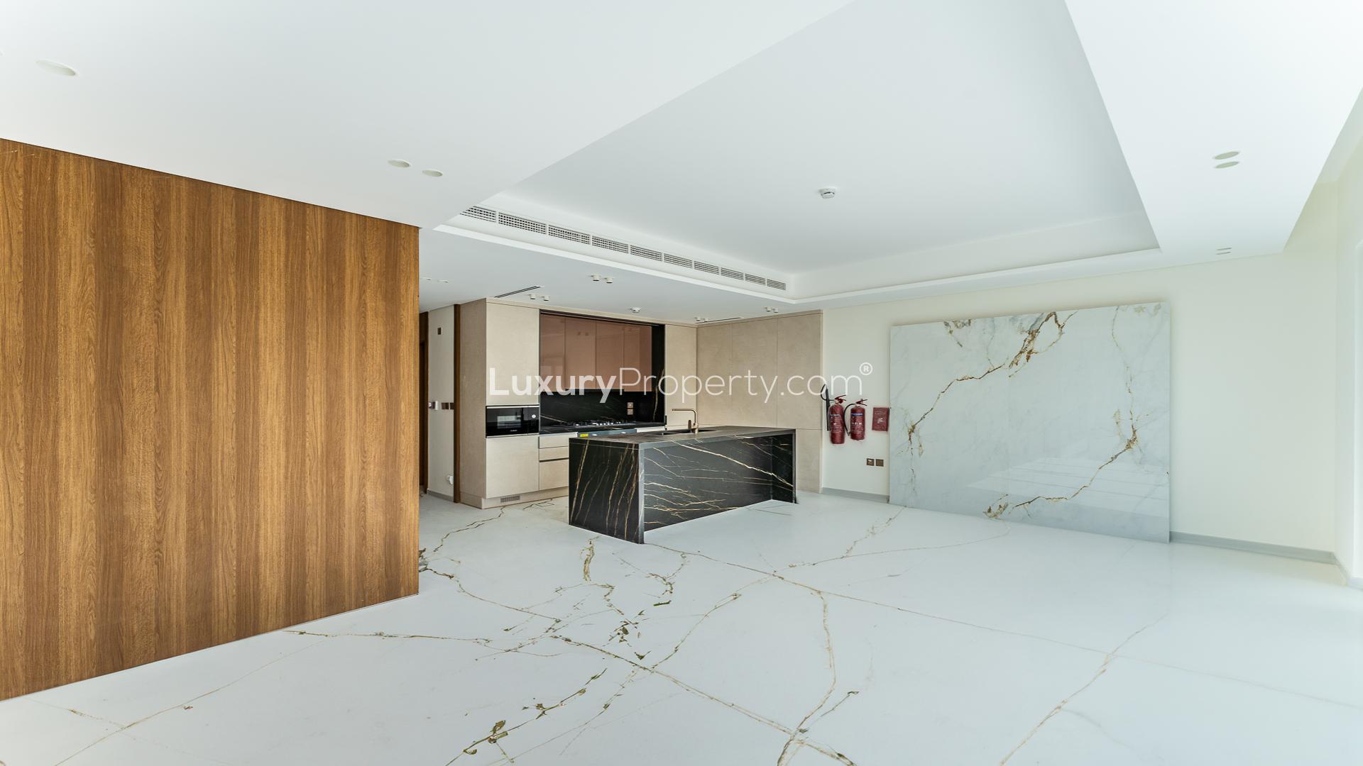 Modern living room with marble floors and large windows in Jasmine Lane townhouse