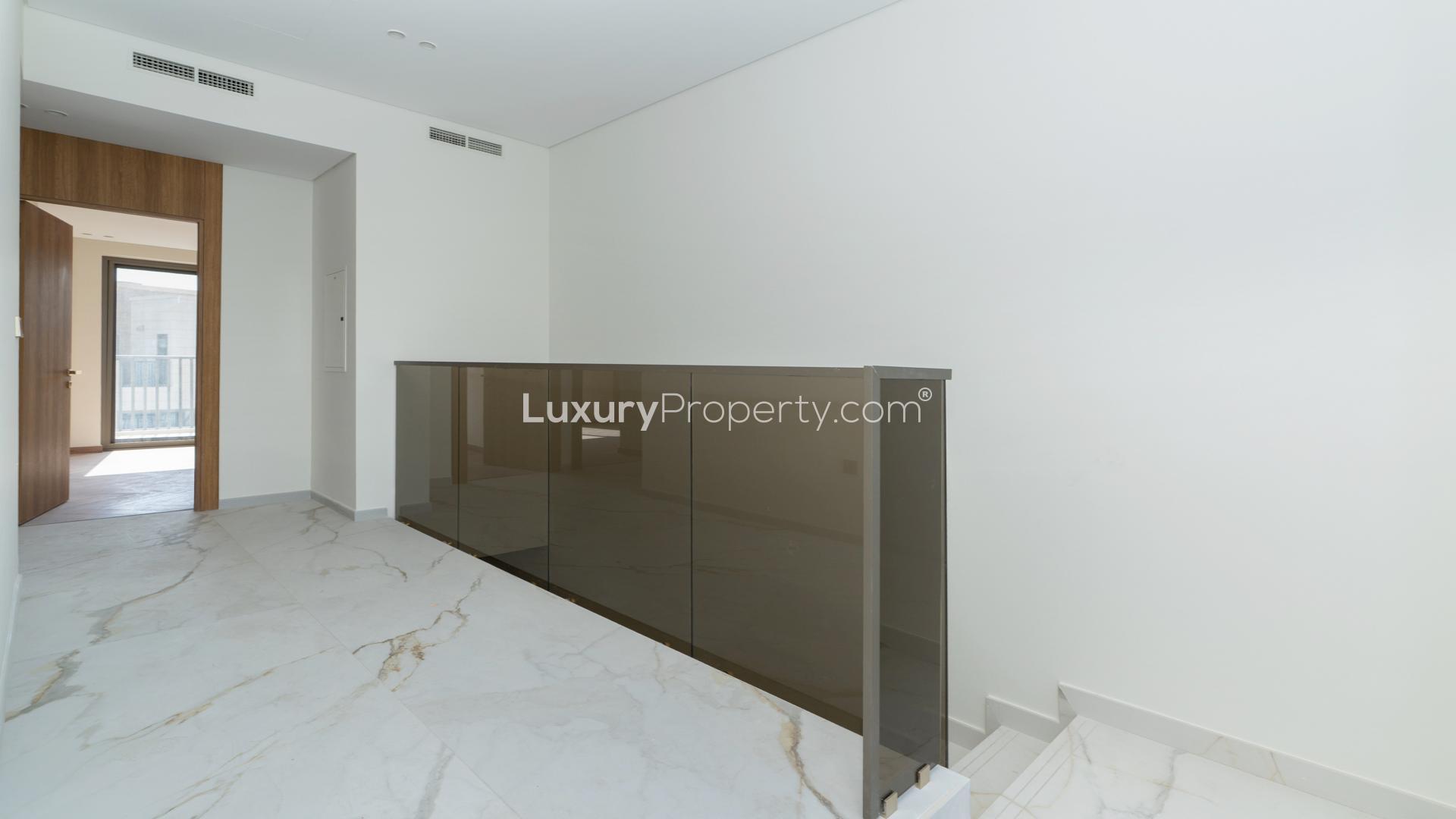 Modern kitchen in Jasmine Lane townhouse, Jumeirah Golf Estates, with sleek design and marble flooring