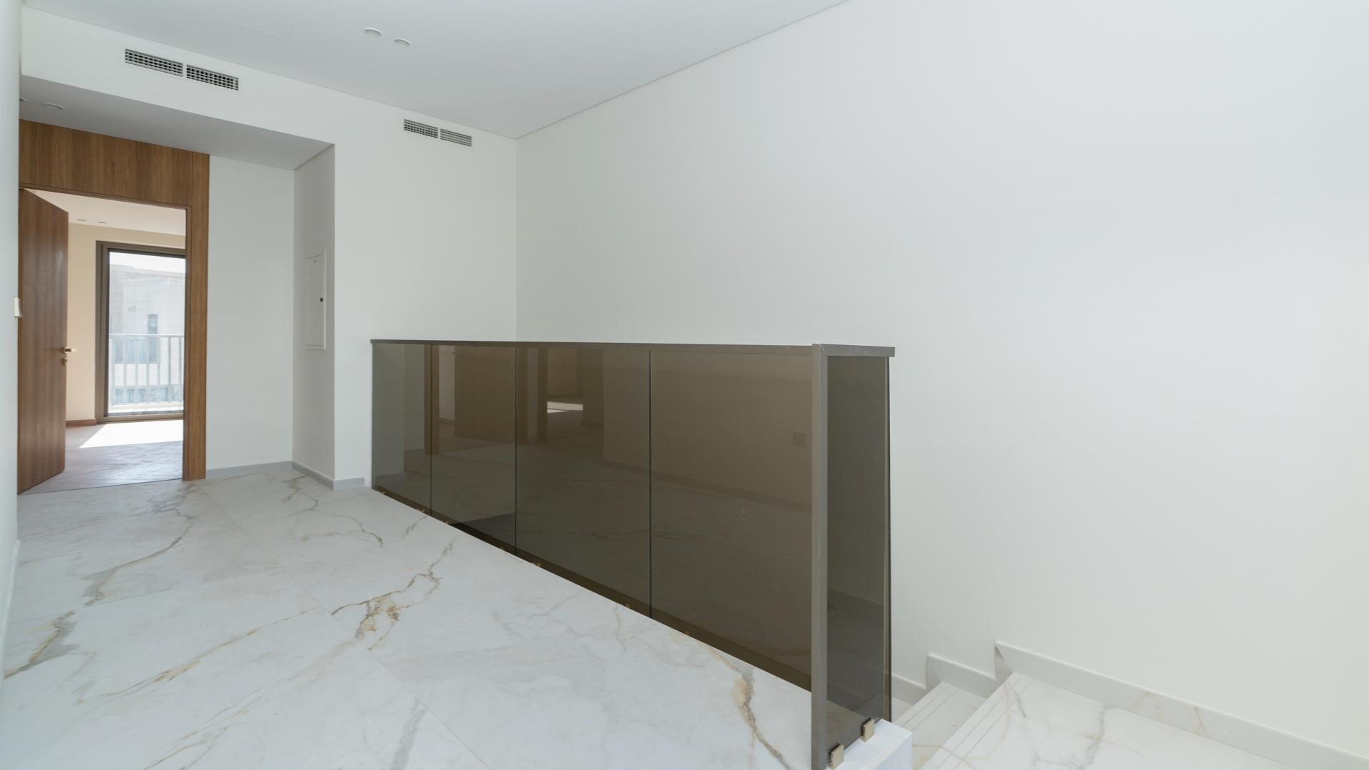 Modern kitchen in Jasmine Lane townhouse, Jumeirah Golf Estates, with sleek design and marble flooring