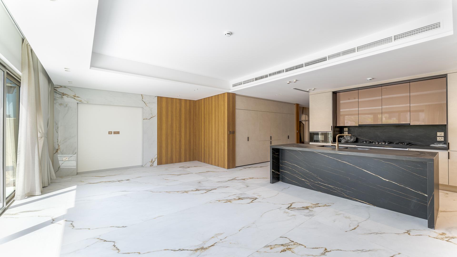 Bright living room with marble floors and garden view in Jasmine Lane townhouse