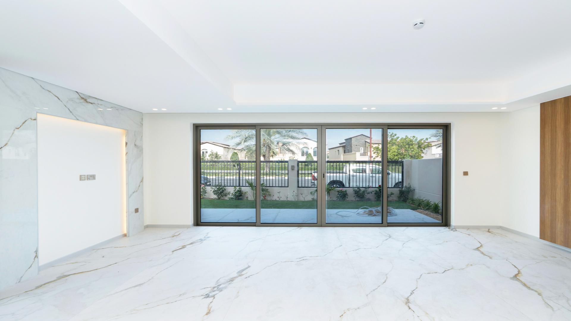 Modern kitchen with island and large windows in Jasmine Lane townhouse, Jumeirah Golf Estates