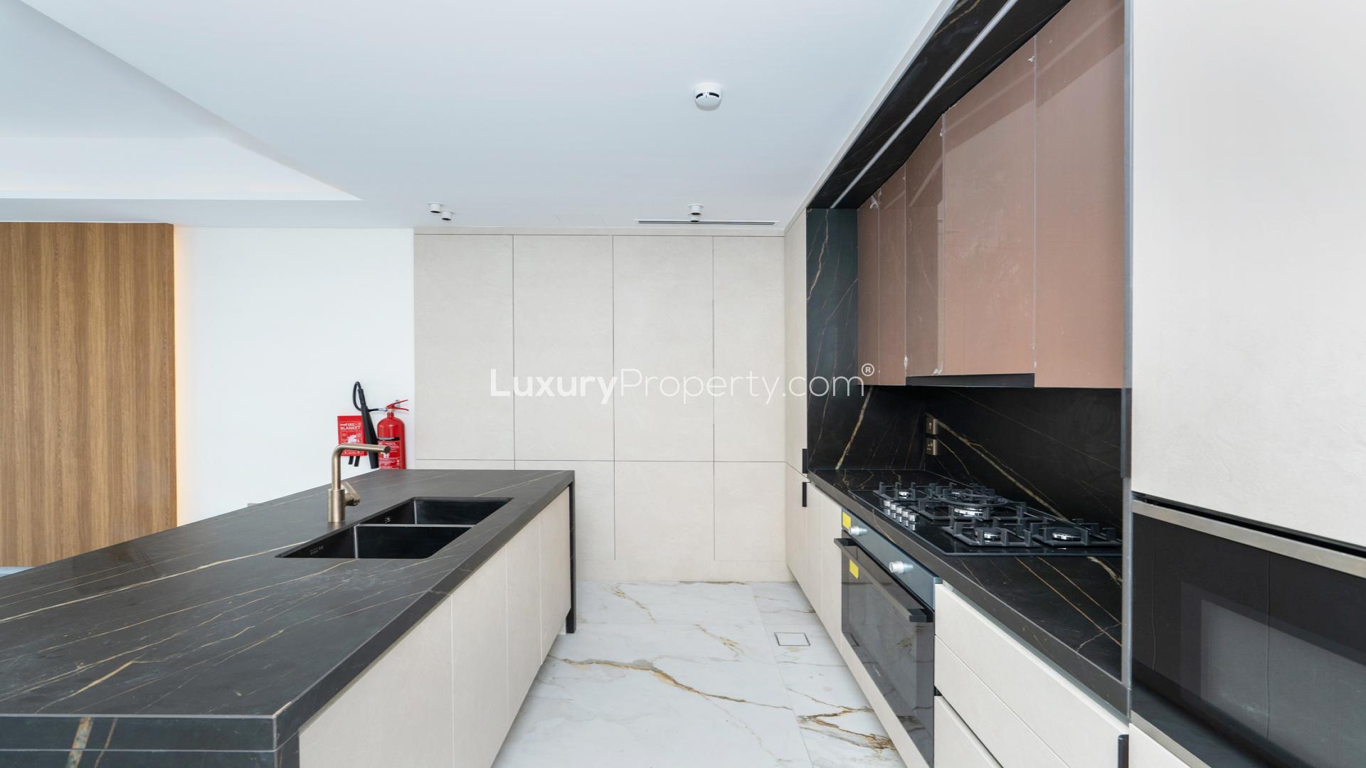 Modern kitchen with sleek design in 3-bedroom townhouse, Jasmine Lane, Jumeirah Golf Estates