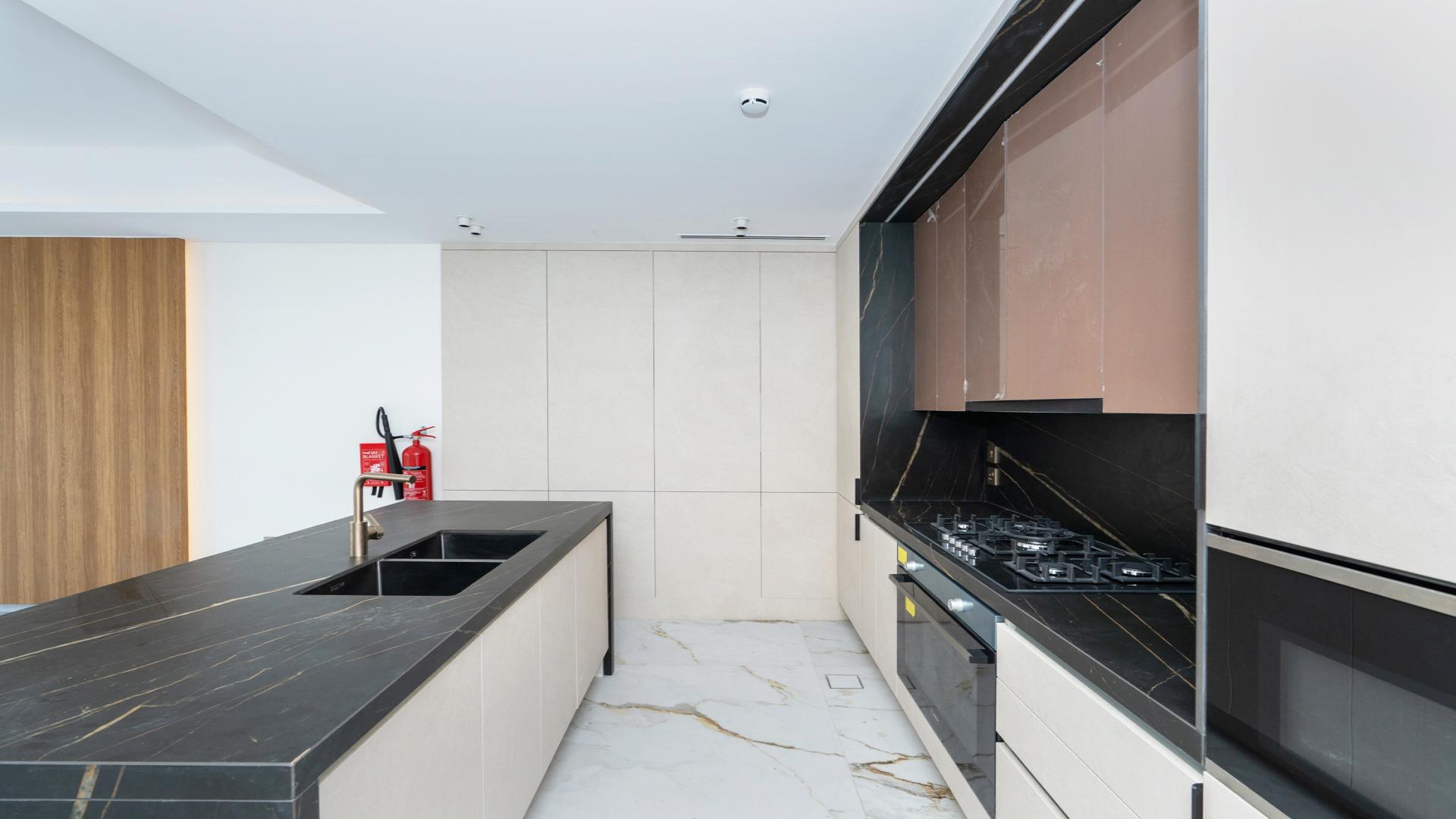Modern kitchen with sleek design in 3-bedroom townhouse, Jasmine Lane, Jumeirah Golf Estates