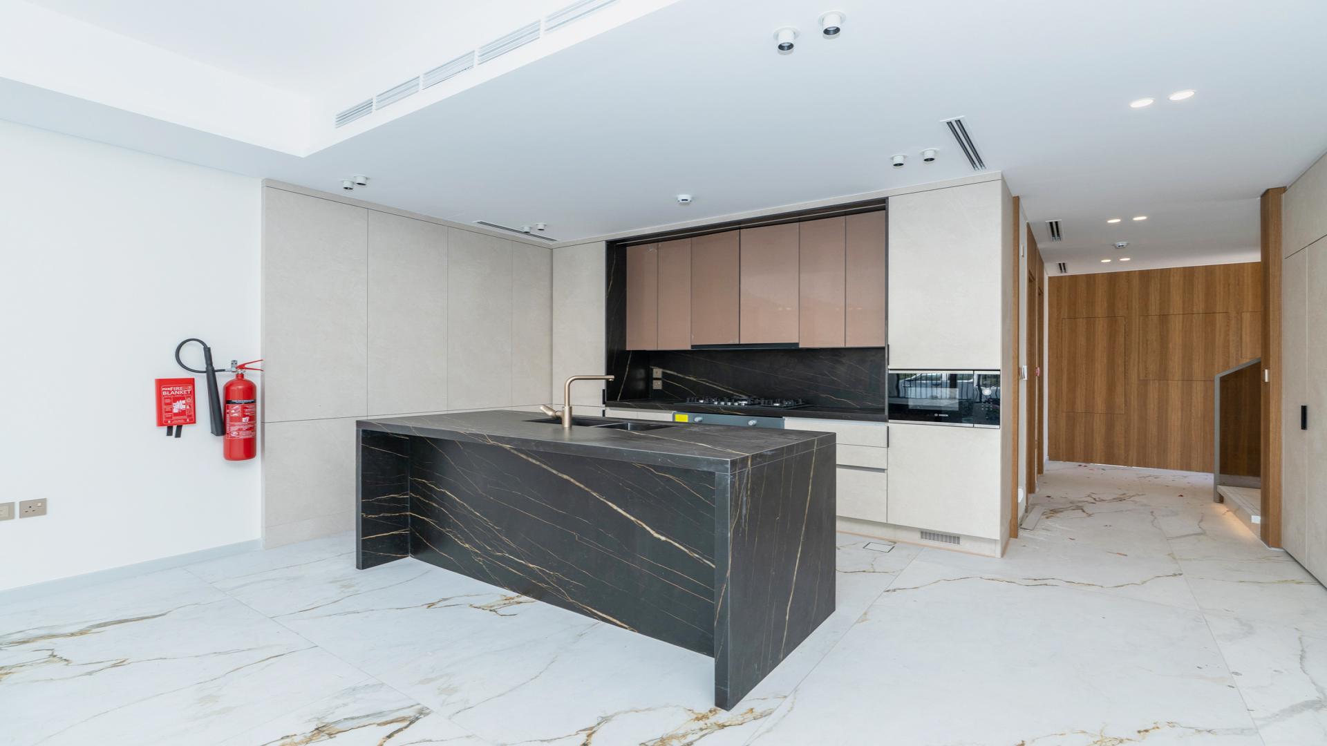 Modern kitchen and living area in Jasmine Lane townhouse, Jumeirah Golf Estates