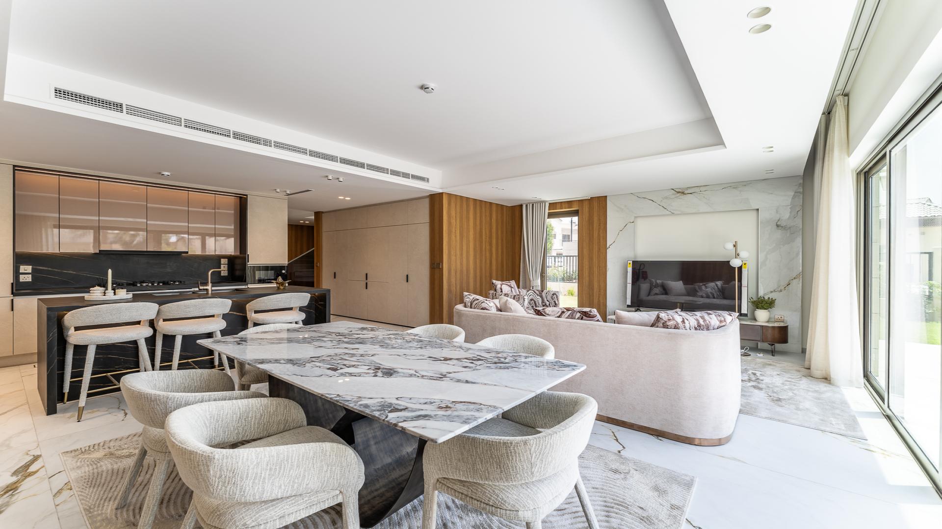 Modern living room in Jasmine Lane Townhouse, Jumeirah Golf Estates, with elegant interiors