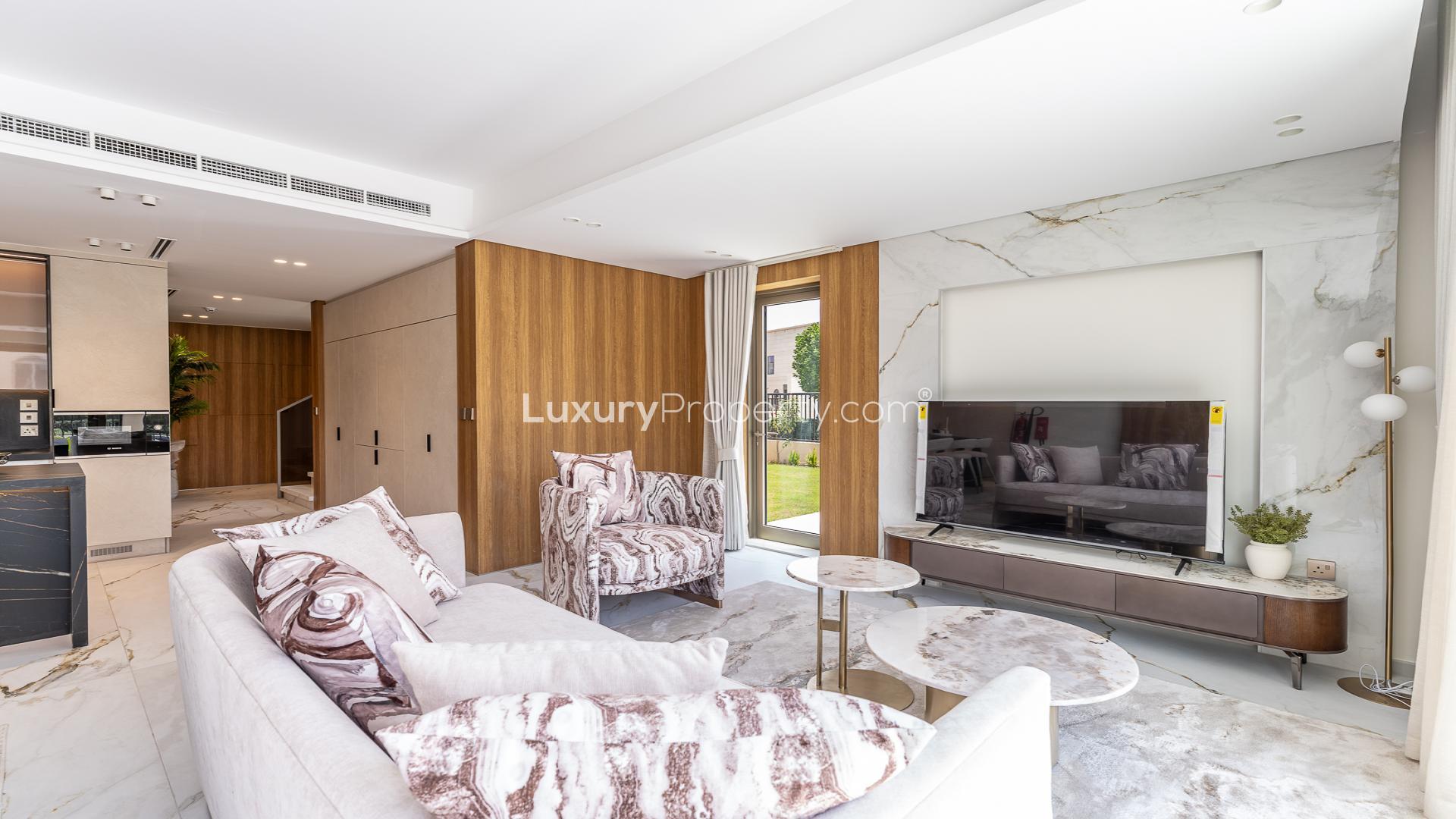 Modern open-plan living room and kitchen in Jasmine Lane townhouse, Jumeirah Golf Estates