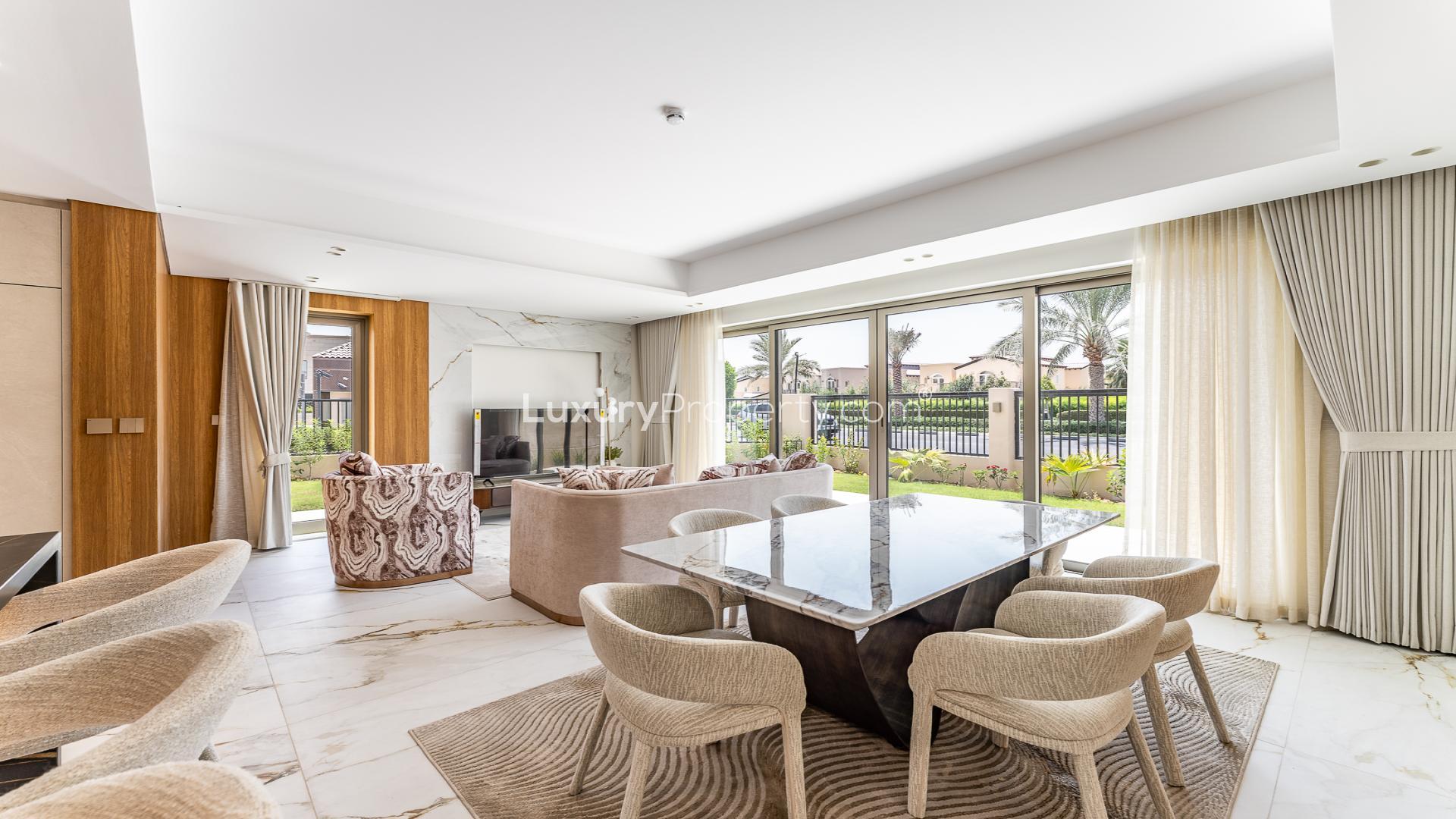 Jasmine Lane townhouse exterior with balconies, modern design, lush lawn, Jumeirah Golf Estates