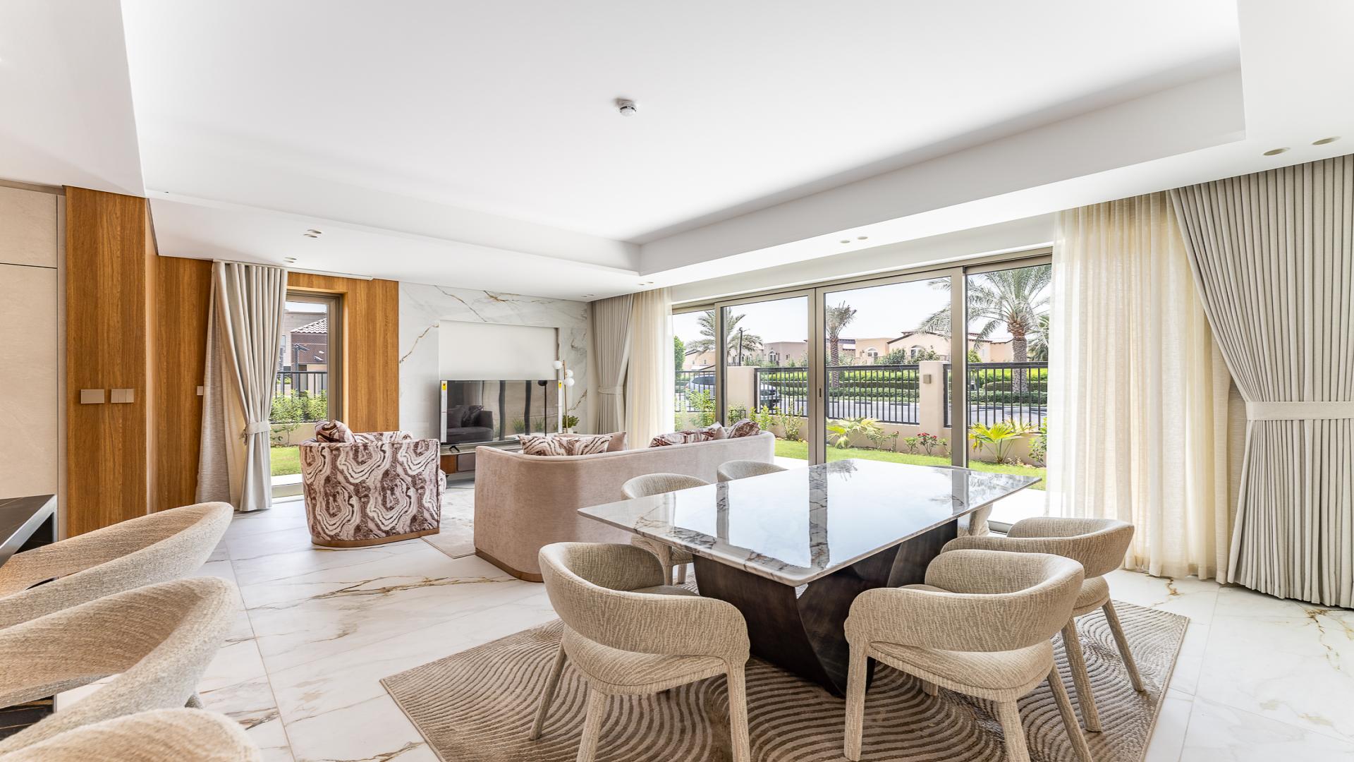 Jasmine Lane townhouse exterior with balconies, modern design, lush lawn, Jumeirah Golf Estates