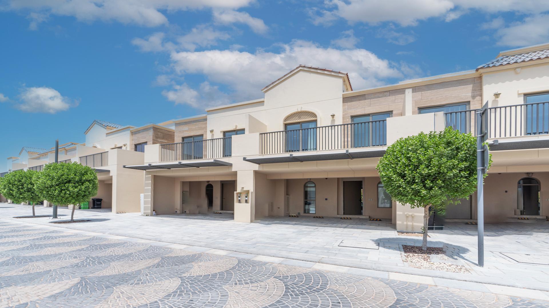 Modern living room in Jasmine Lane townhouse, Jumeirah Golf Estates, with garden view