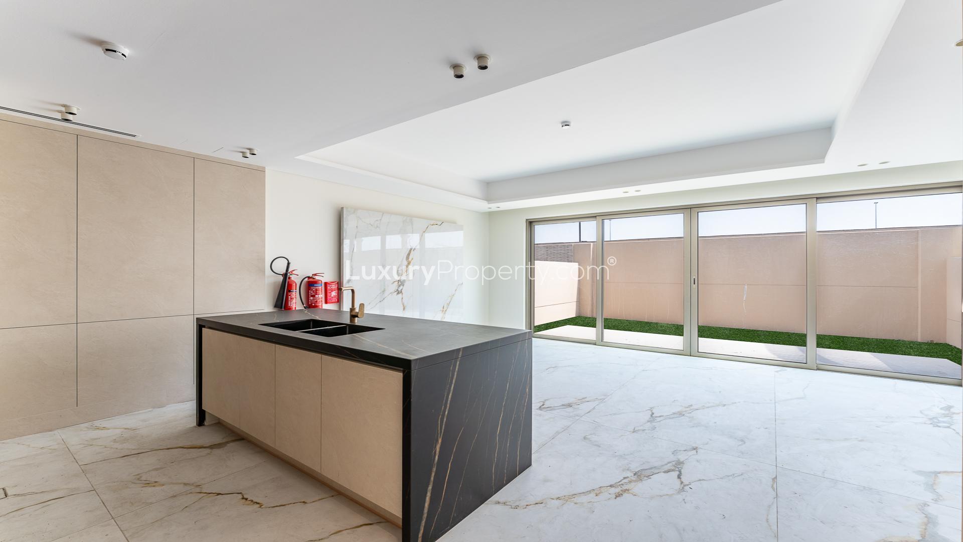 Brand new kitchen in Jumeirah Golf Estates townhouse, featuring elegant marble flooring and countertops