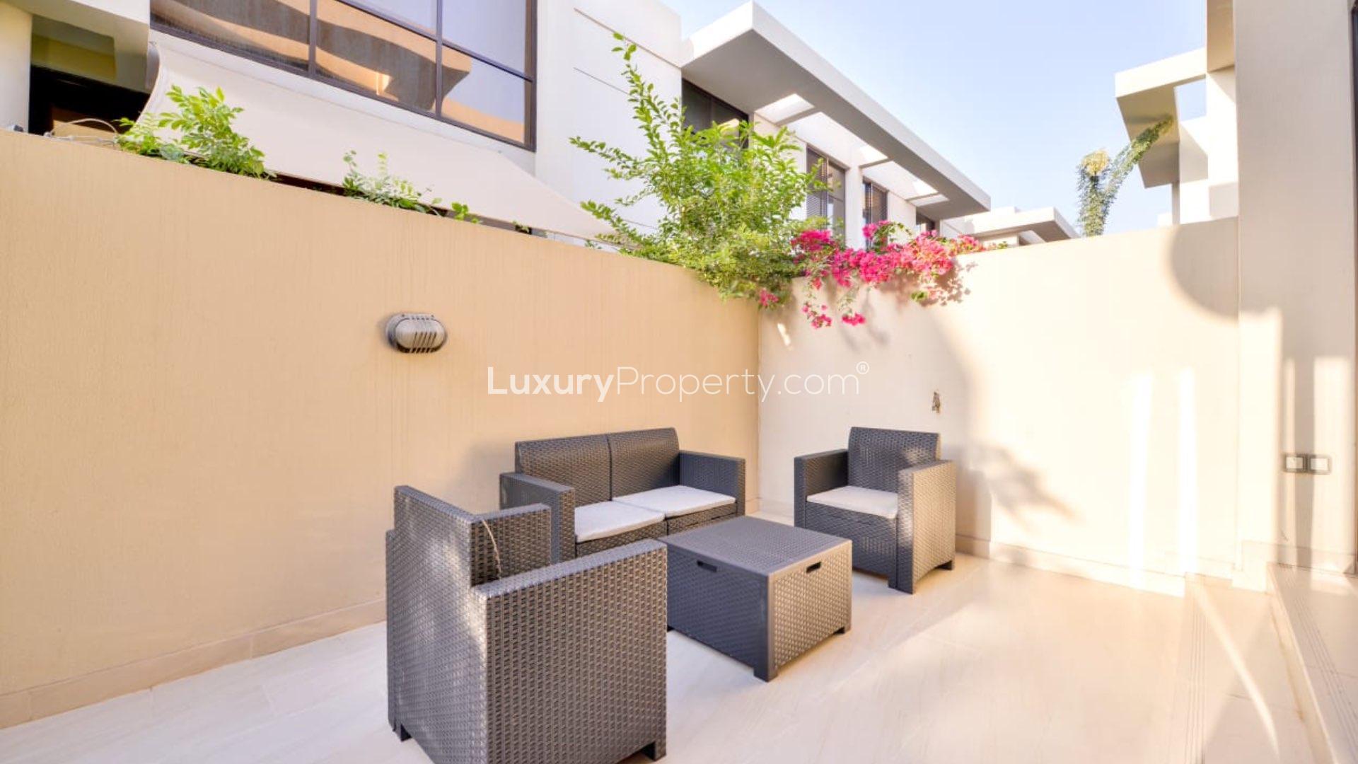 N/A,Outdoor patio with modern wicker furniture in Damac Hills townhouse, Topanga community