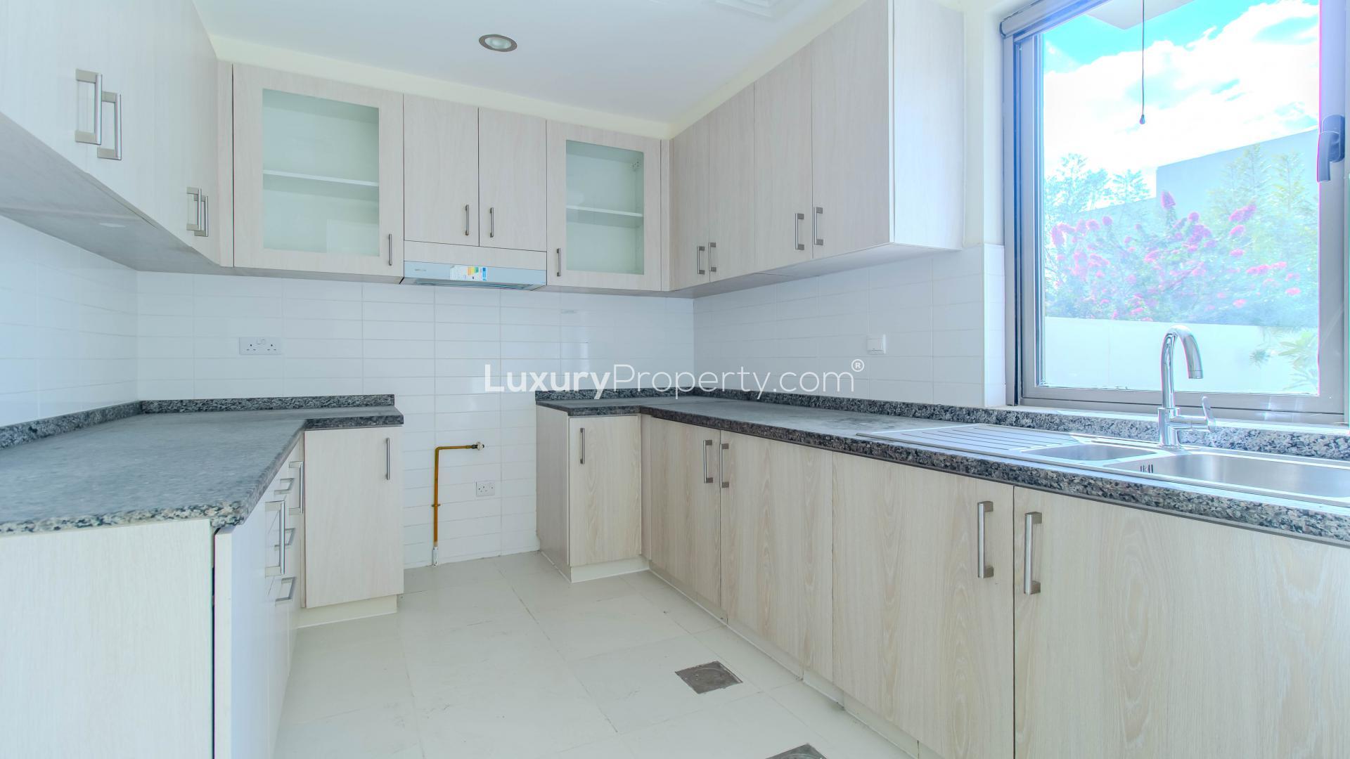 Modern kitchen with granite countertops in Mira Oasis villa, Reem community, for rent