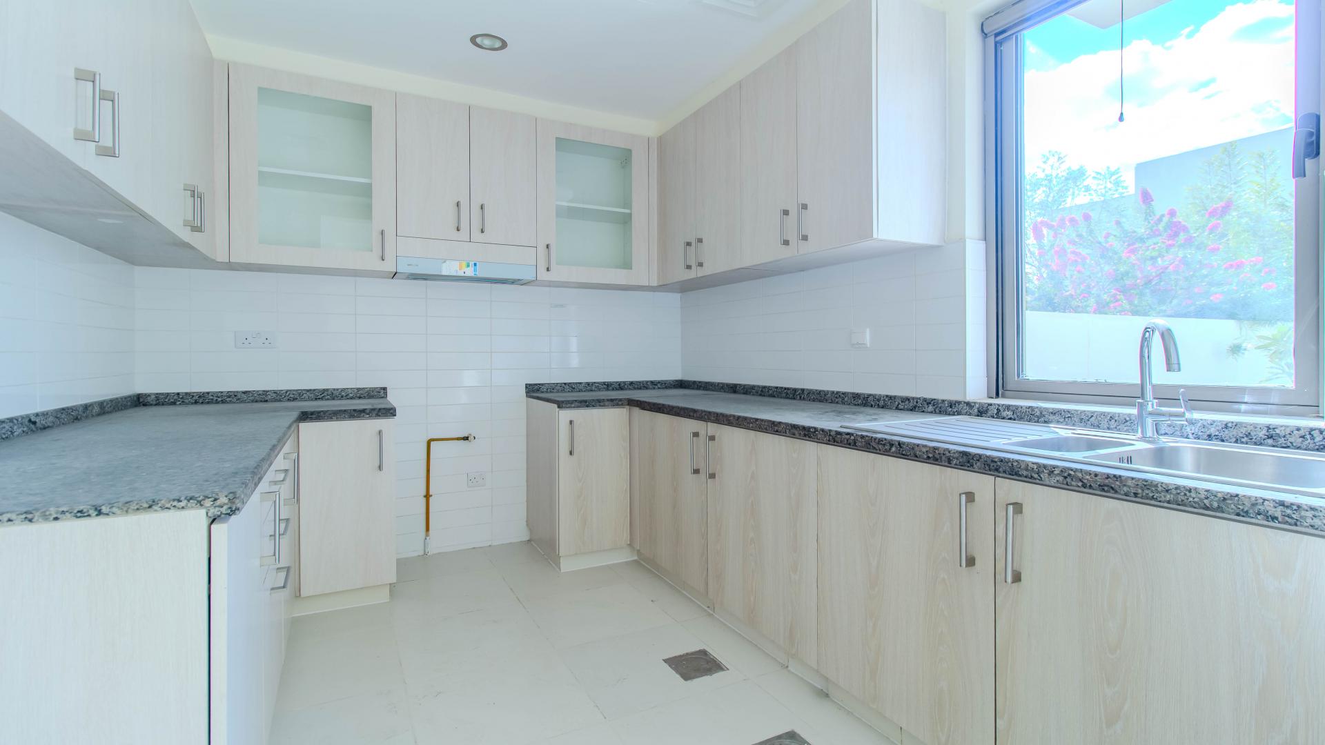Modern kitchen with granite countertops in Mira Oasis villa, Reem community, for rent