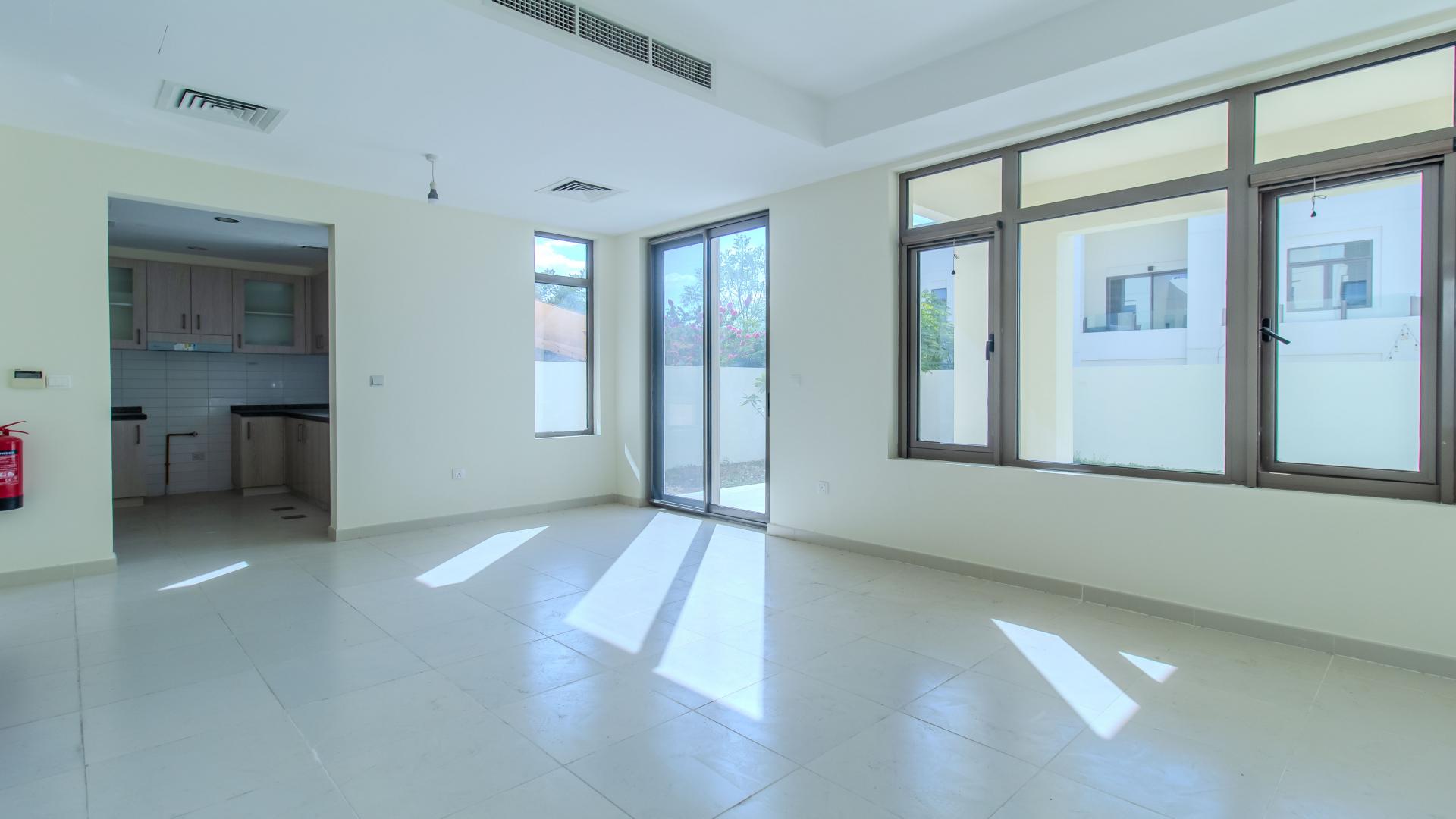 "Bright living room with large windows in Mira Oasis villa, Reem community rental.",Modern villa interior with large windows and open layout in Mira Oasis, Reem
