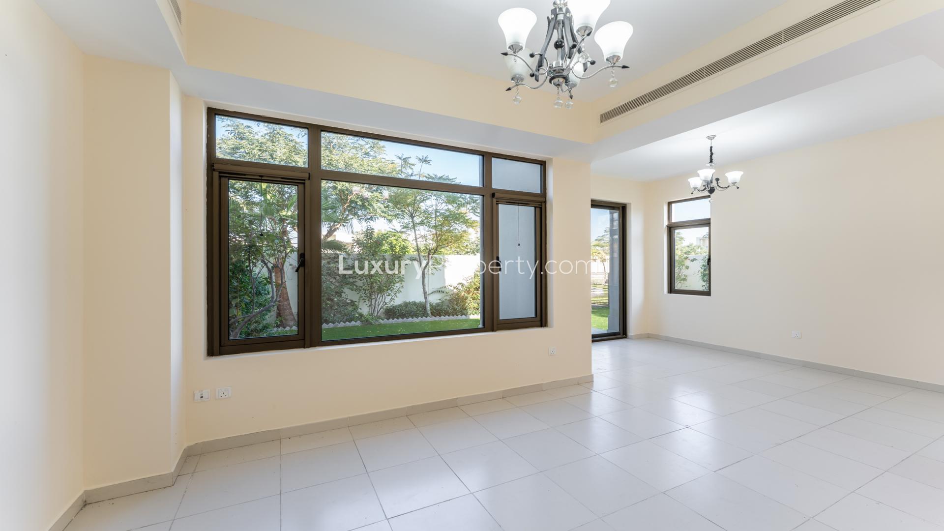 Modern townhouse garden with lush greenery, steps, and sliding glass doors in Mira Oasis, Reem