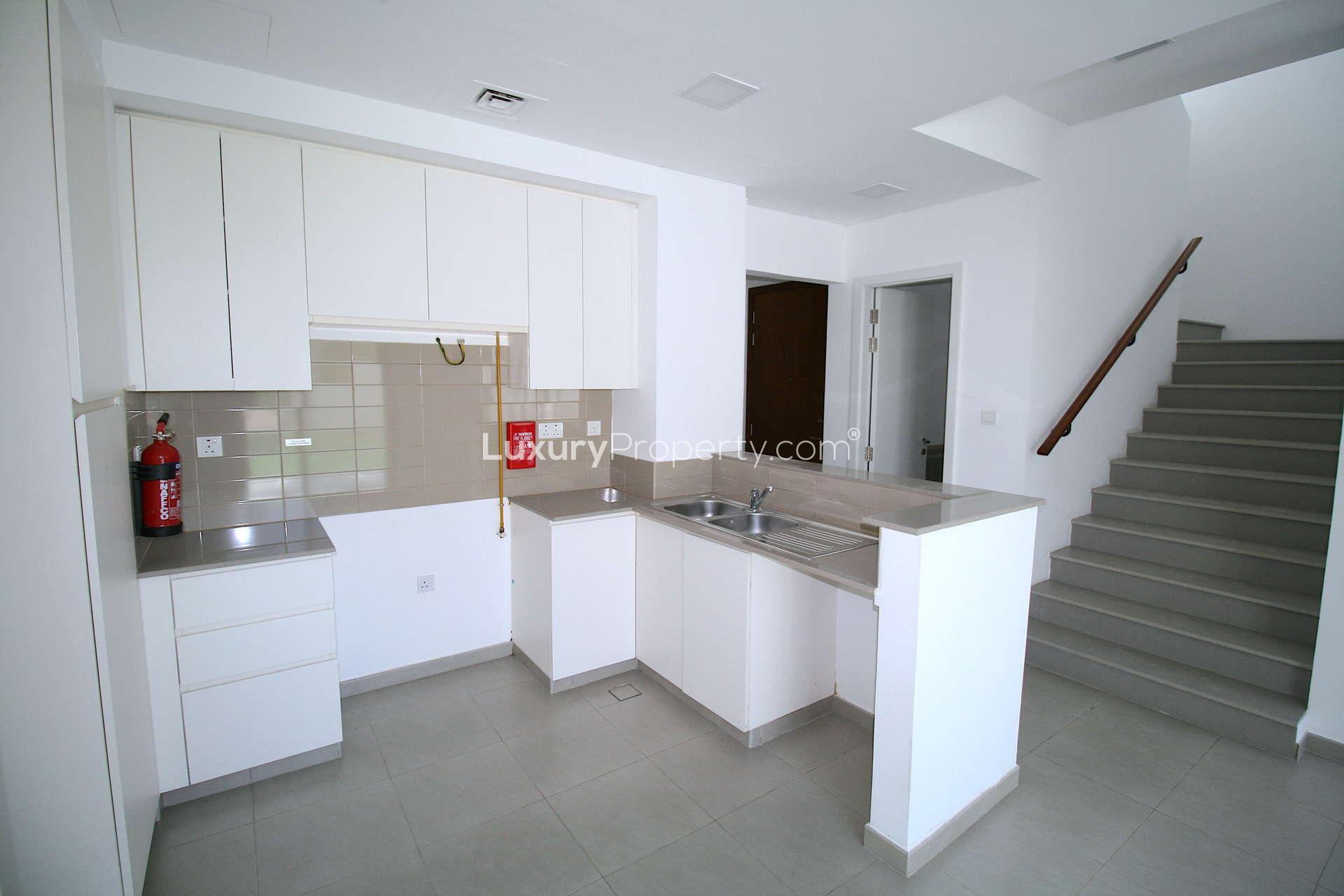 Open-plan kitchen and living area in Zahra Townhouses, Town Square, ready-to-move 3-bedroom