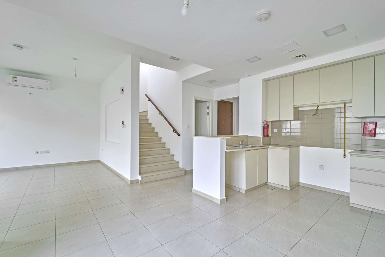 Bright living area with sliding glass doors in Zahra Townhouse, Town Square rental