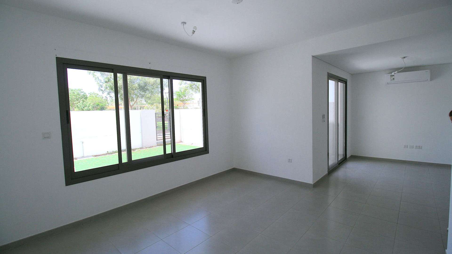 Modern kitchen and living area in Zahra Townhouse, Town Square, Dubai for rent