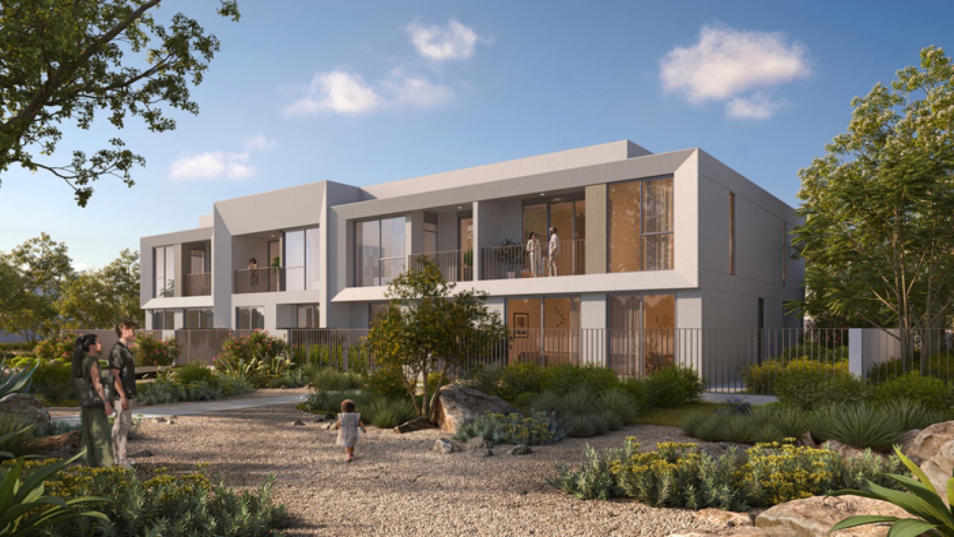 Modern townhouse exterior in Velora 2, The Valley, featuring landscaped gardens and balconies