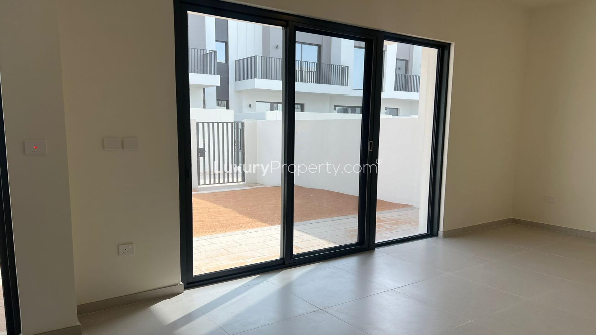 Modern kitchen and living area in Emaar Greenview Villas townhouse, Madinat Al Mataar