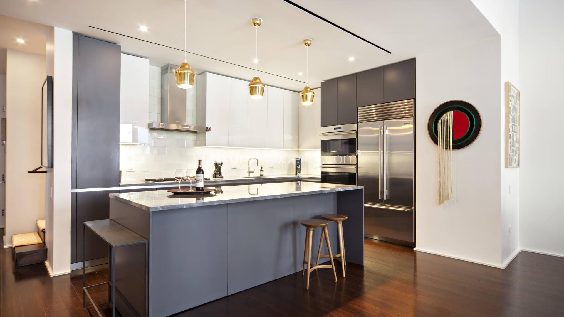 Luxurious outdoor patio with seating and fireplace in Manhattan townhouse, 10 Bond Street, New York