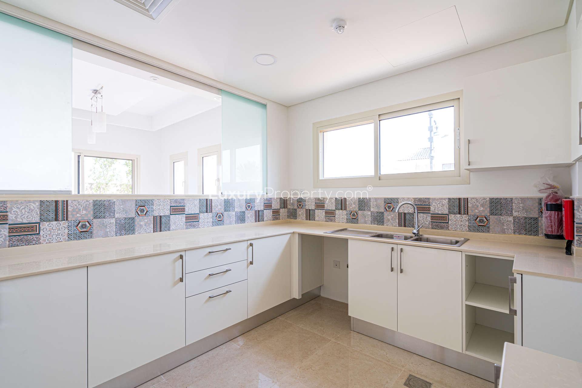 Bright living room with large windows in Al Andalus townhouse, Jumeirah Golf Estates