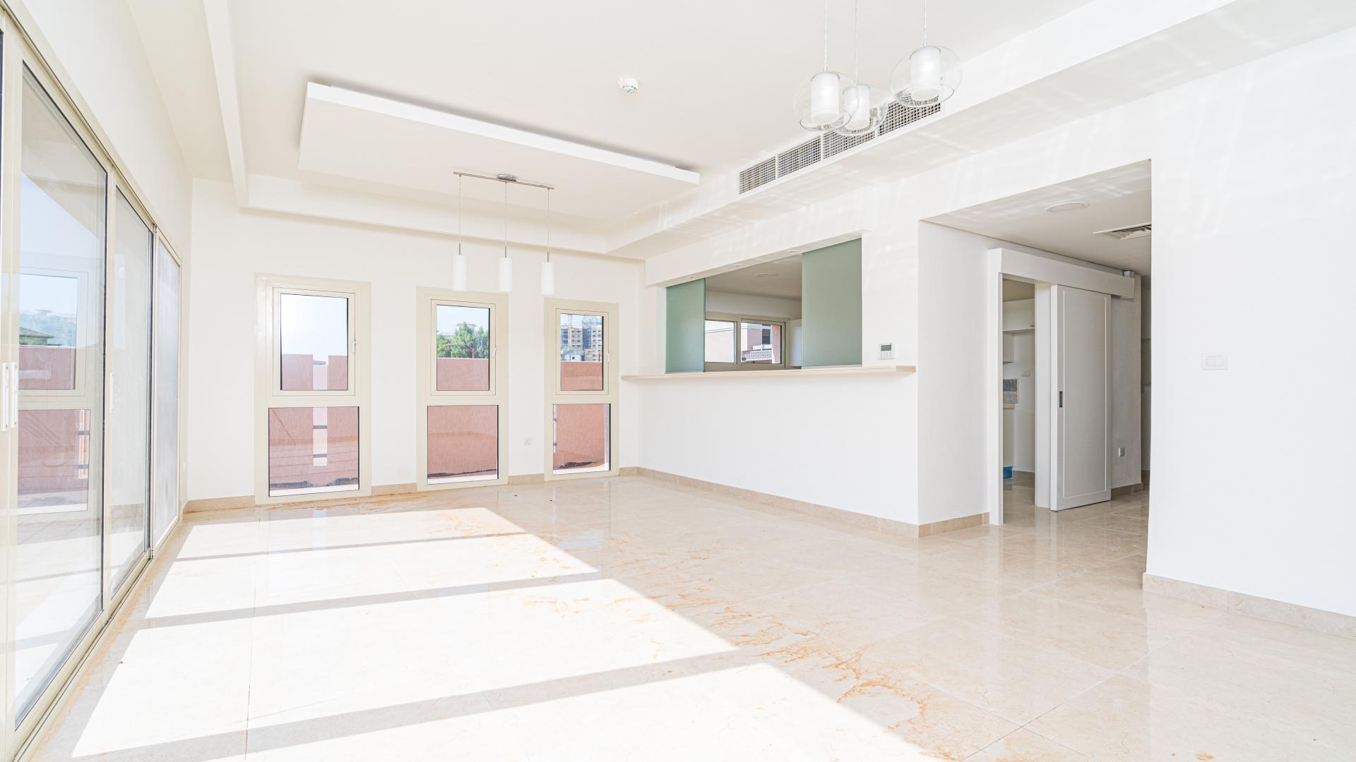 Single row townhouse in Al Andalus, Jumeirah Golf Estates, featuring modern architecture and landscaping