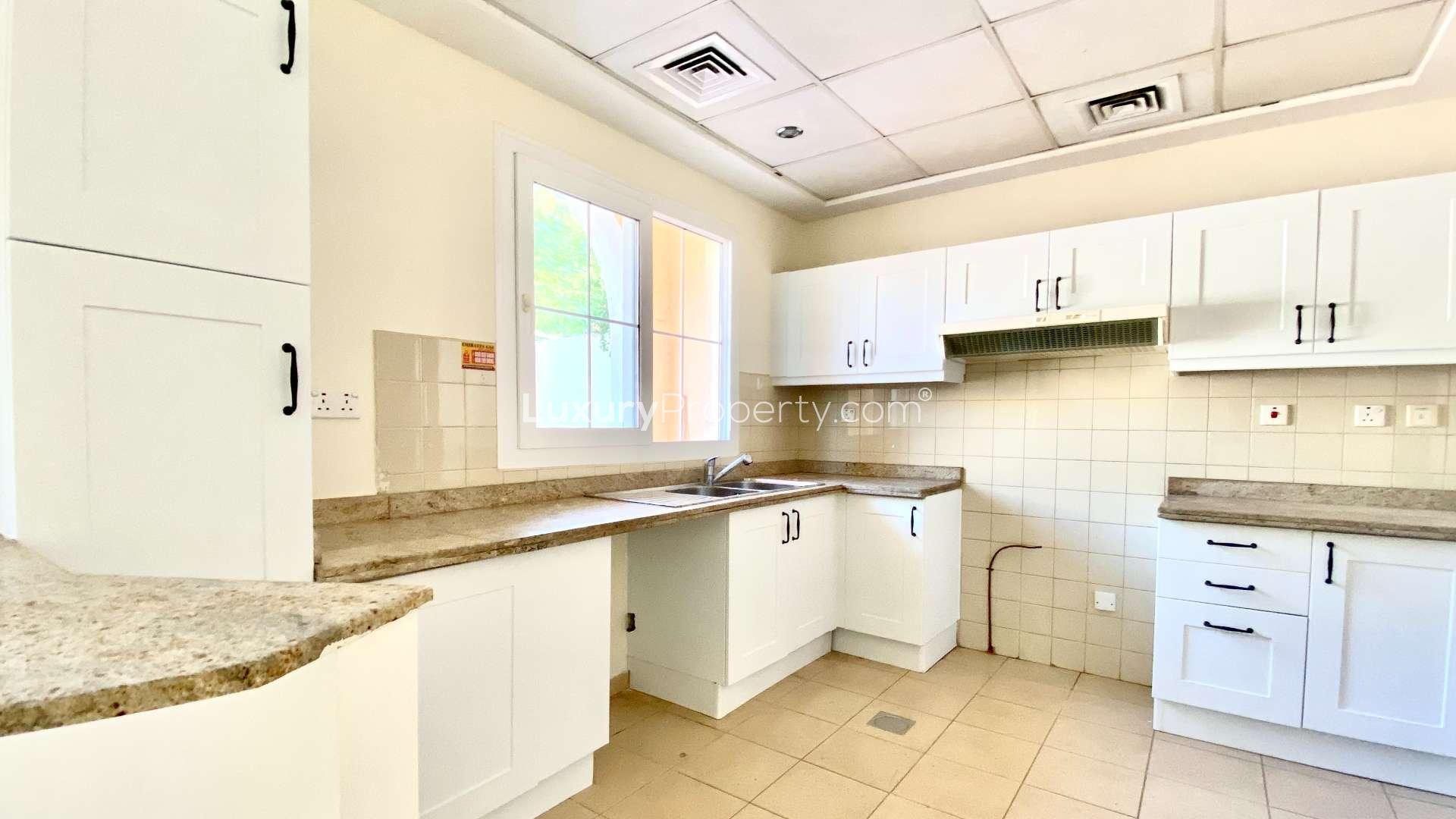 Lush landscaped pathway in Al Reem, Arabian Ranches townhouse community for sale