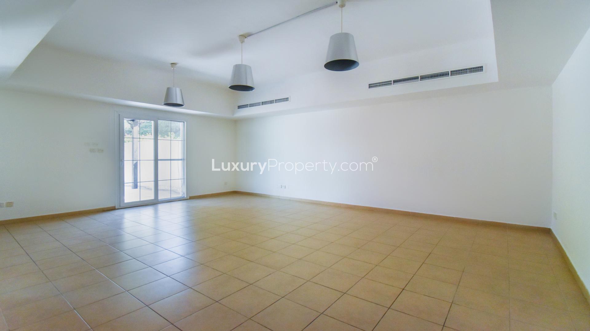 "Front view of Al Reem townhouse with carport, Arabian Ranches 1, for sale.",Empty living room with tiled floor in 3-bedroom townhouse, Al Reem, Arabian Ranches 1