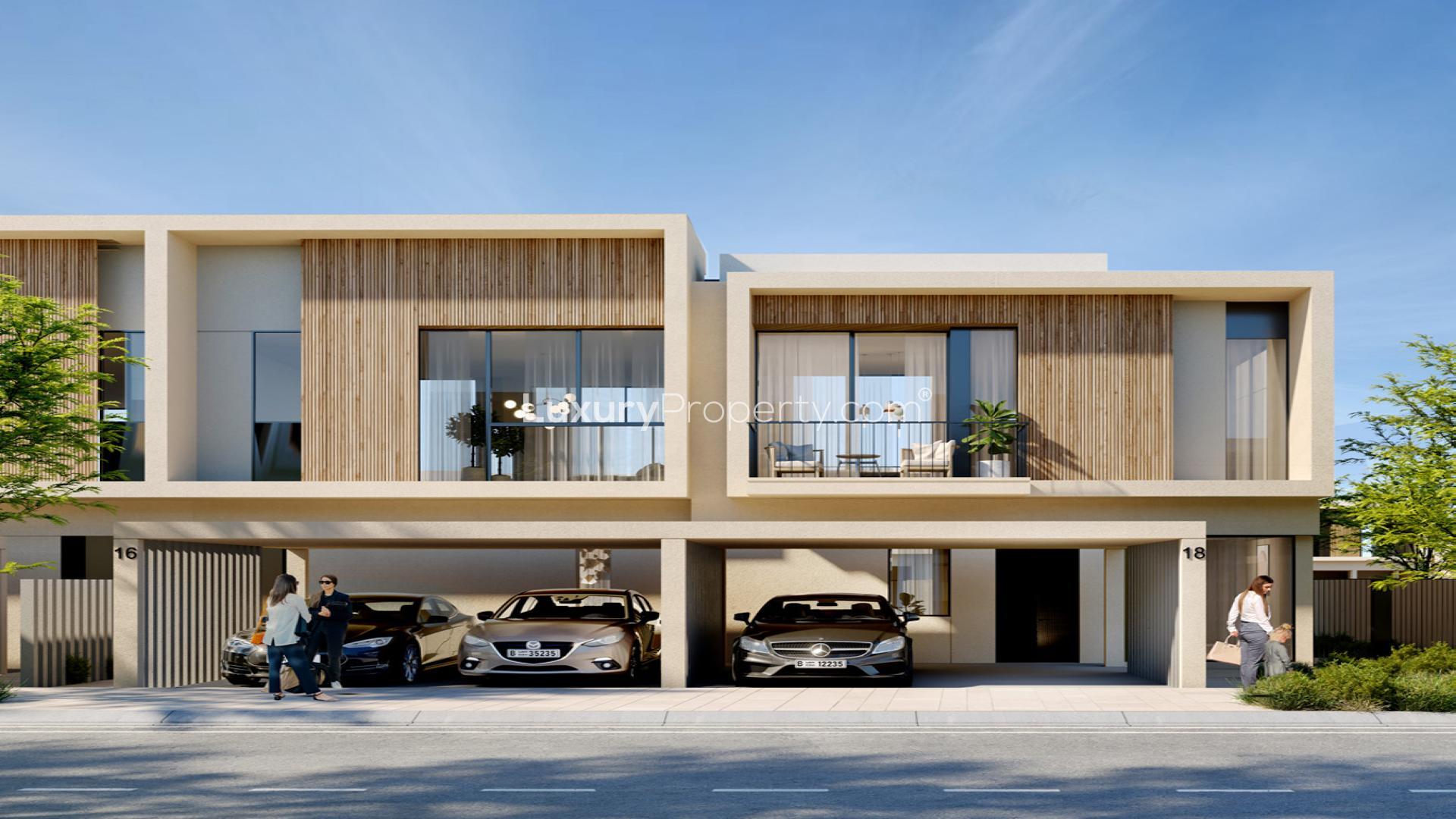 Modern townhouse exterior in Orania, The Valley, surrounded by lush landscaping and pathways