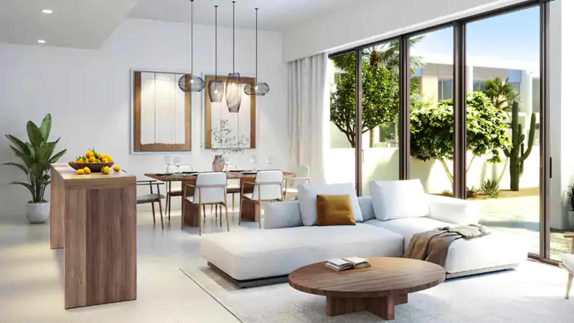 Modern living room and kitchen in Orania townhouse, The Valley, with garden view