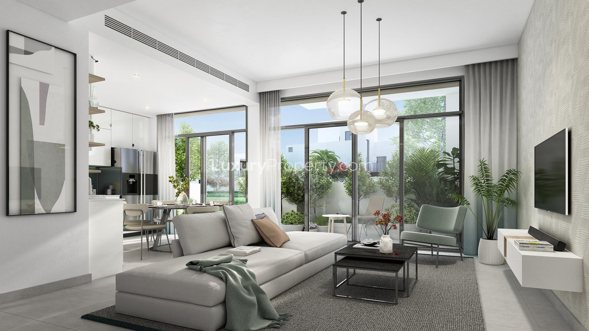 Modern living room in Arabian Ranches 3 townhouse, featuring sleek decor and large windows