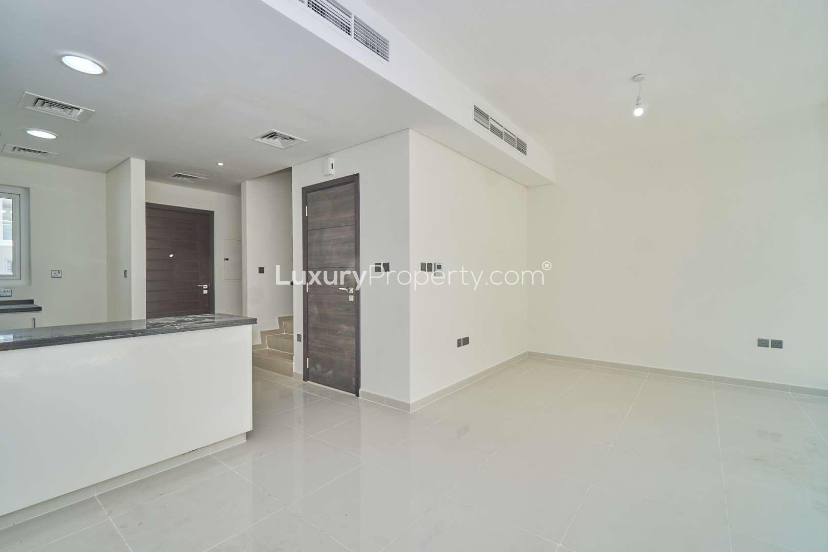 "Modern 3-bedroom townhouse exterior in Albizia, Damac Hills 2, Akoya community for sale.",Modern interior of 3-bedroom townhouse for sale in Albizia, Damac Hills 2, Akoya
