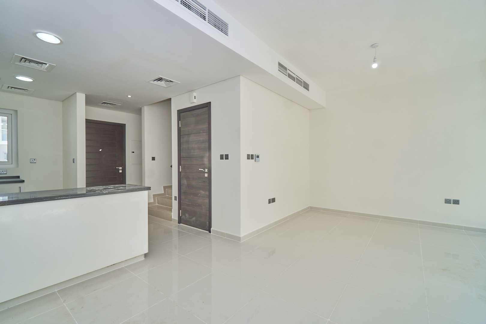 "Modern 3-bedroom townhouse exterior in Albizia, Damac Hills 2, Akoya community for sale.",Modern interior of 3-bedroom townhouse for sale in Albizia, Damac Hills 2, Akoya