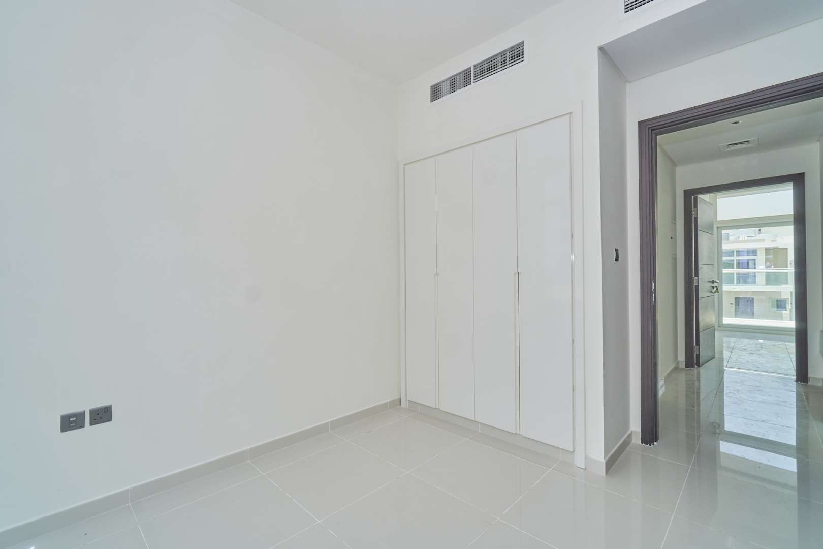 Empty room with built-in wardrobe in Albizia Damac Hills 2 townhouse for sale