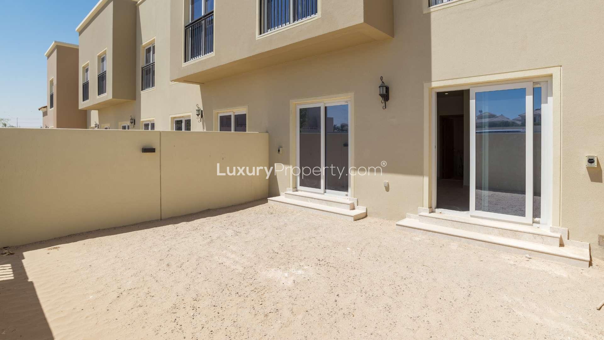 "Private backyard of three-bedroom townhouse in Amaranta, Villanova for sale, LP07081.",Exterior view of Amaranta townhouse patio in Villanova, featuring sliding glass doors