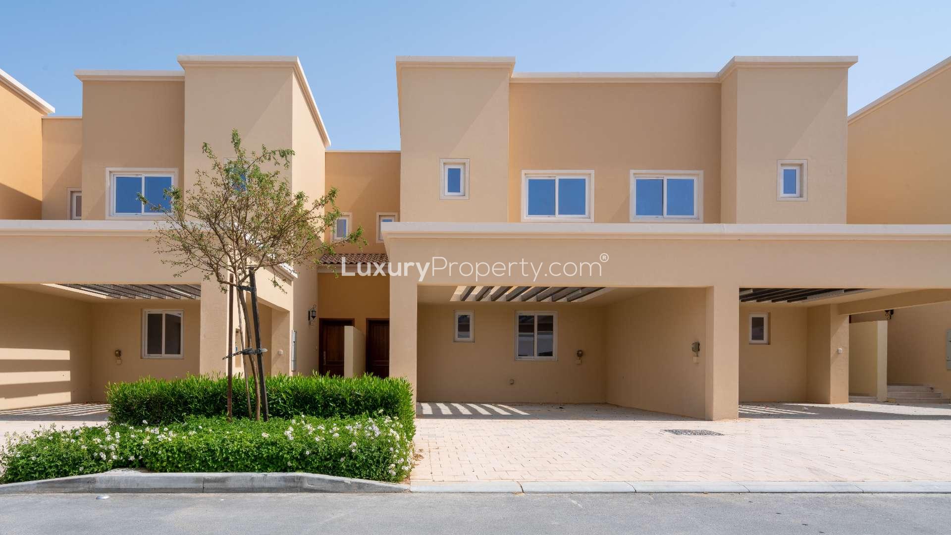 Modern townhouse interior with staircase and open kitchen in Villanova, Dubai Land