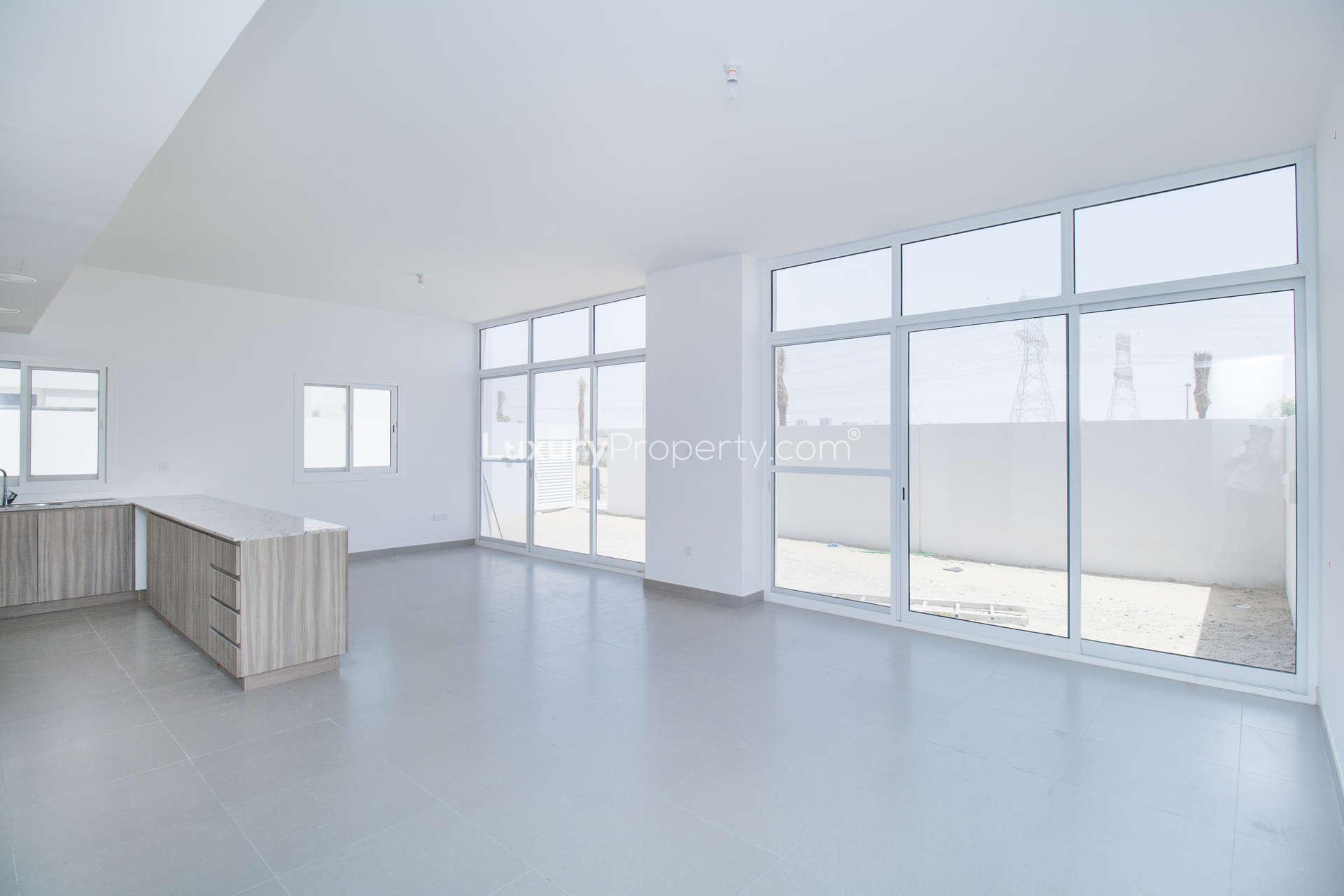 "Bright hallway and staircase in Arabella three-bedroom townhouse, Mudon community for sale.",Bright living area with large windows in Mudon Arabella townhouse for sale