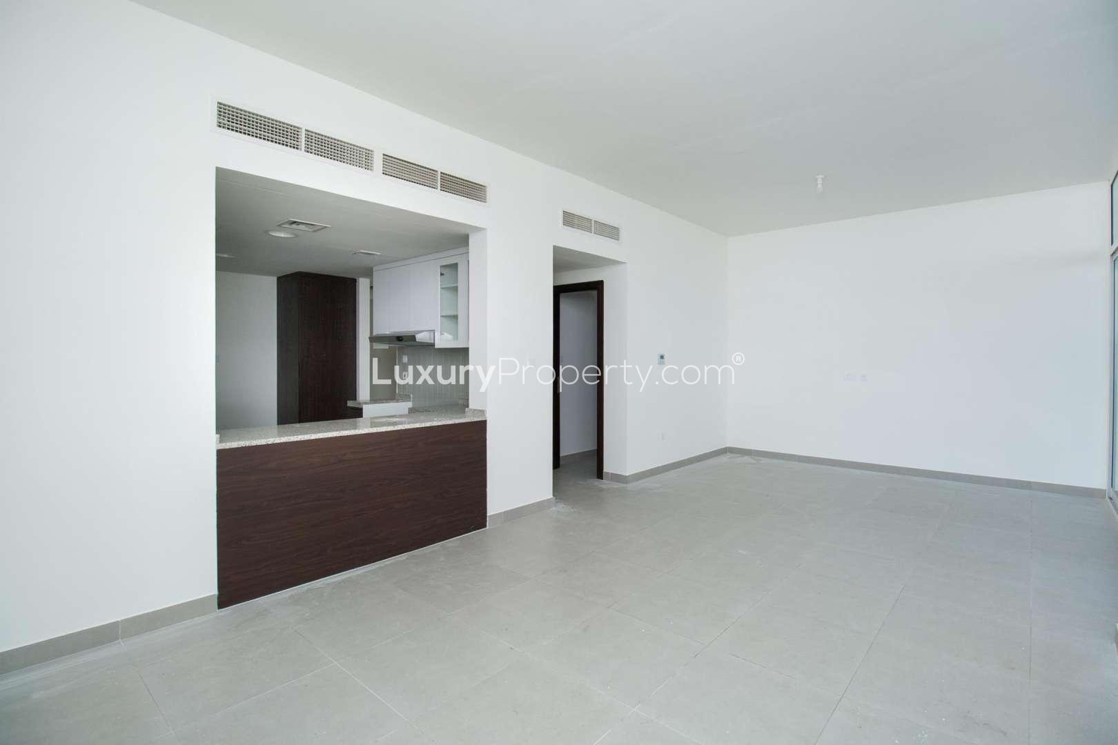 Spacious open-plan living area in Arabella 1 townhouse, Mudon, with modern kitchen design