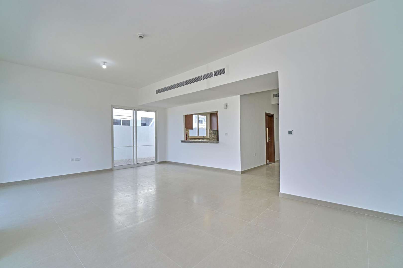 Spacious living area with large windows in Arabella Townhouses, Mudon