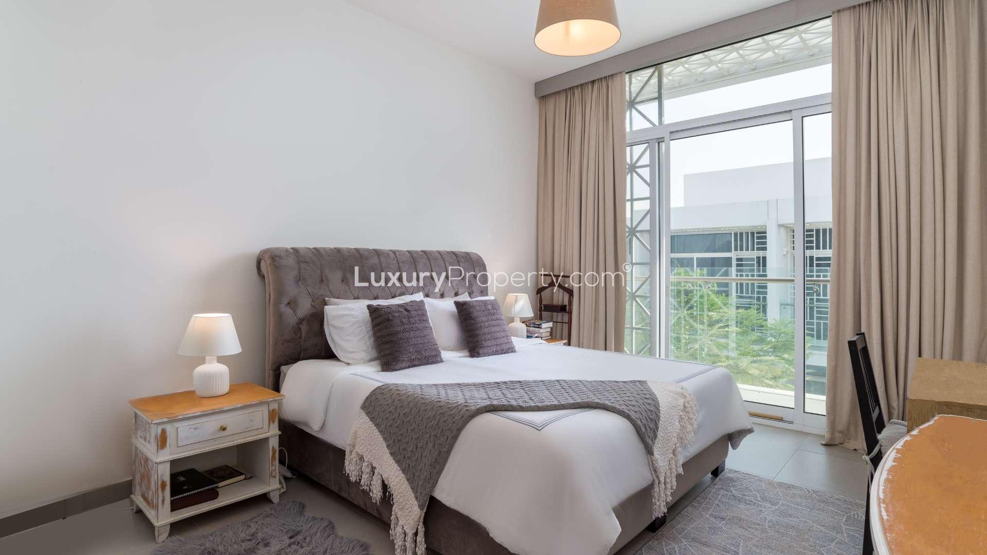 Modern three-bedroom townhouse exterior with parking in Arabella 1, Mudon community