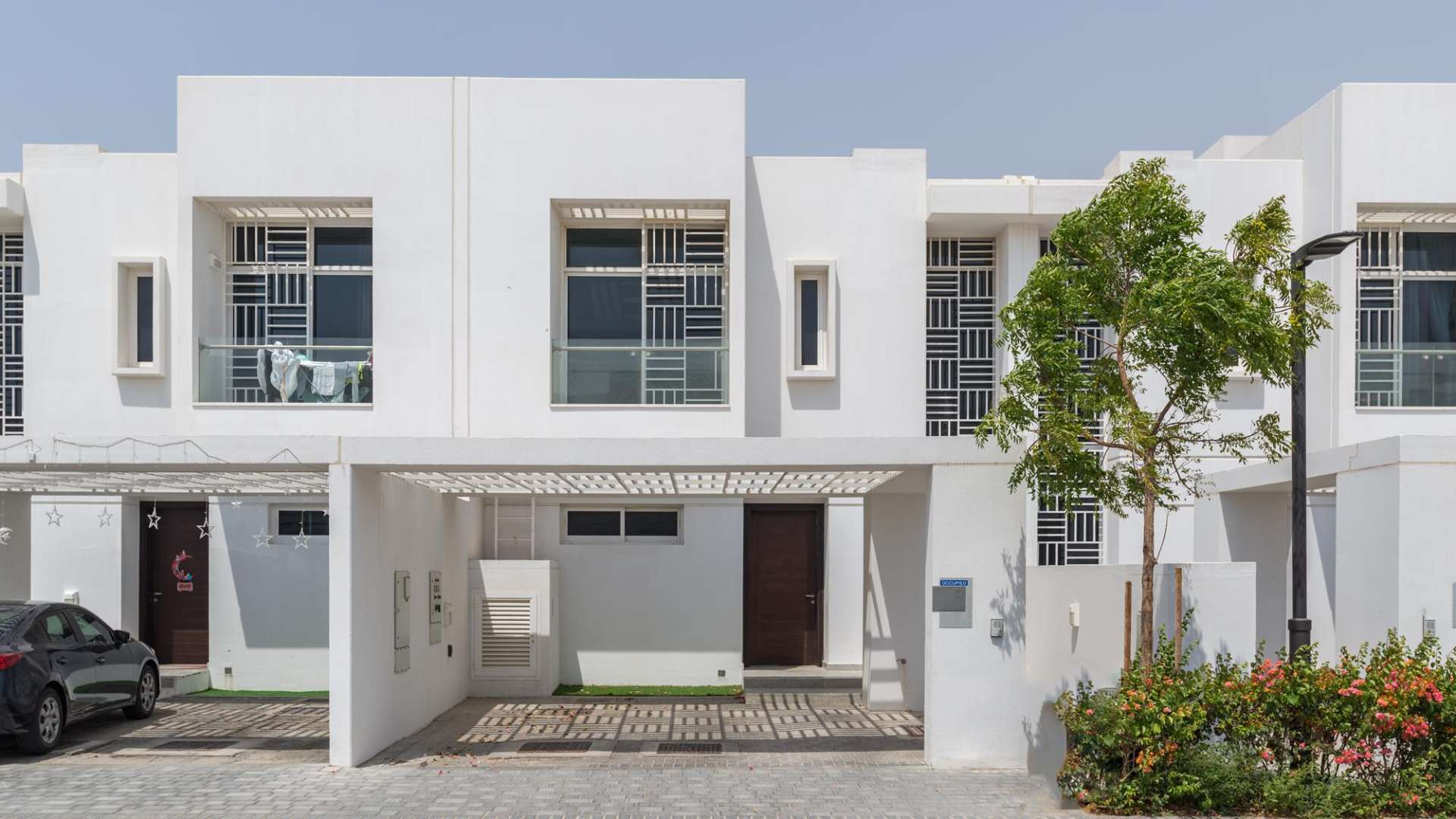 "Modern single row villa entrance in Arabella Townhouses, Mudon, featuring stylish pergola and driveway.",Exceptional 3-bedroom villa exterior in Arabella Townhouses, Mudon, for sale