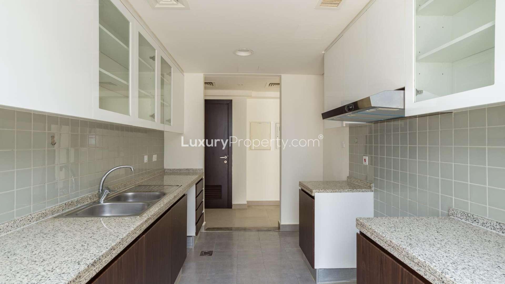 Contemporary Arabella townhouse bedroom with large window and built-in wardrobe in Mudon