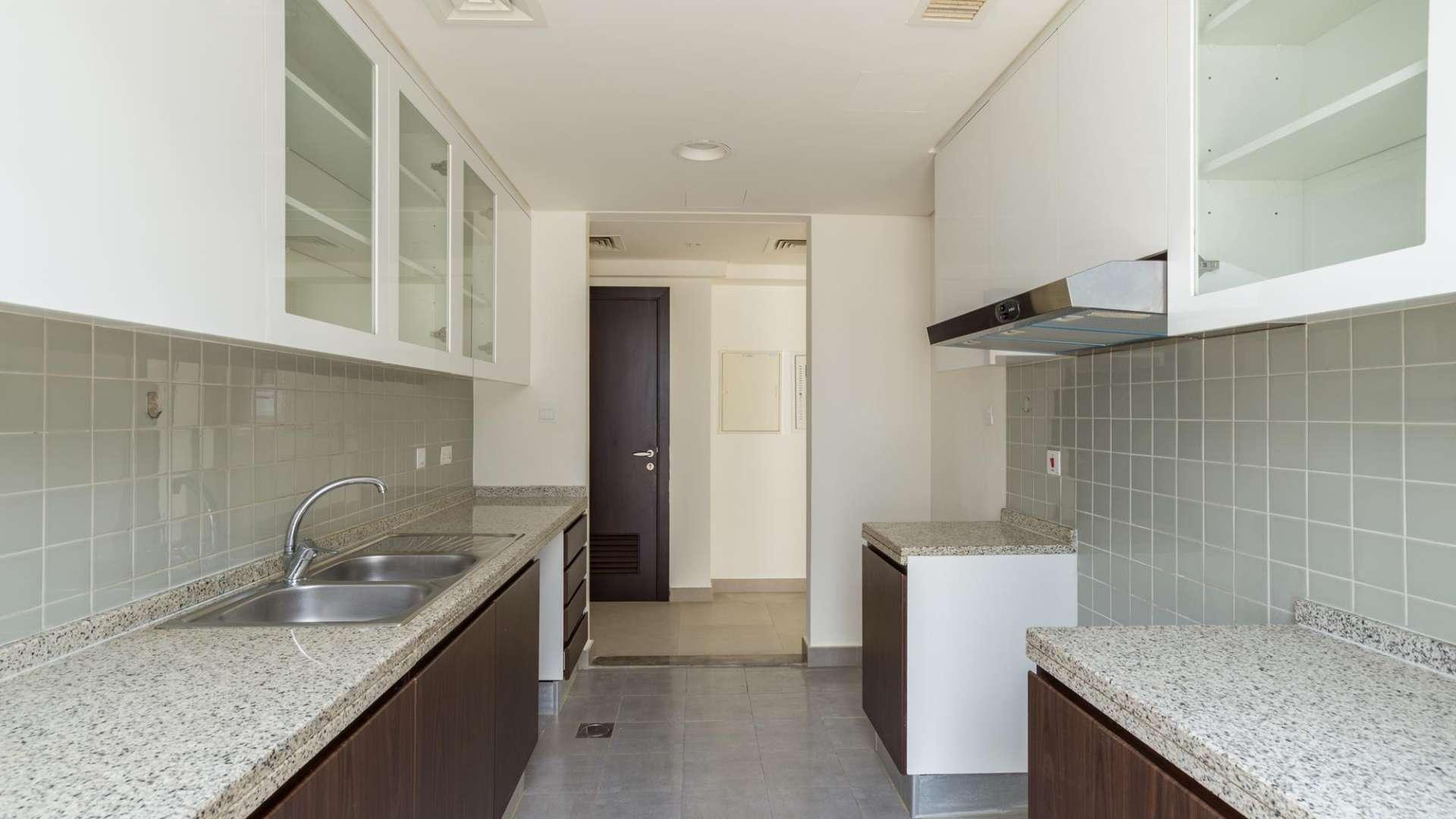 Contemporary Arabella townhouse bedroom with large window and built-in wardrobe in Mudon